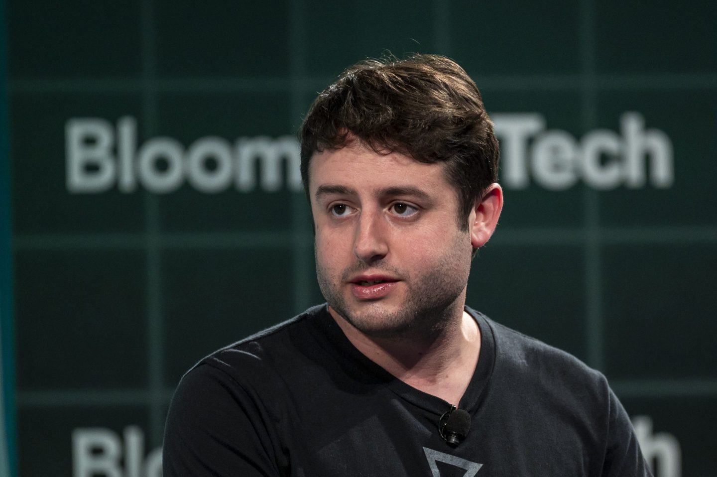 Man in black t-shirt talking