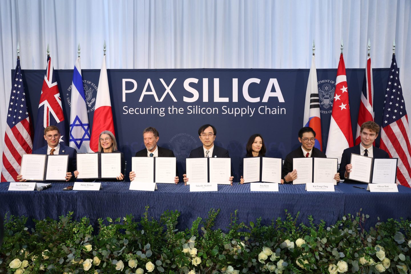 Country representatives hold up letters supporting the Pax Silica effort.