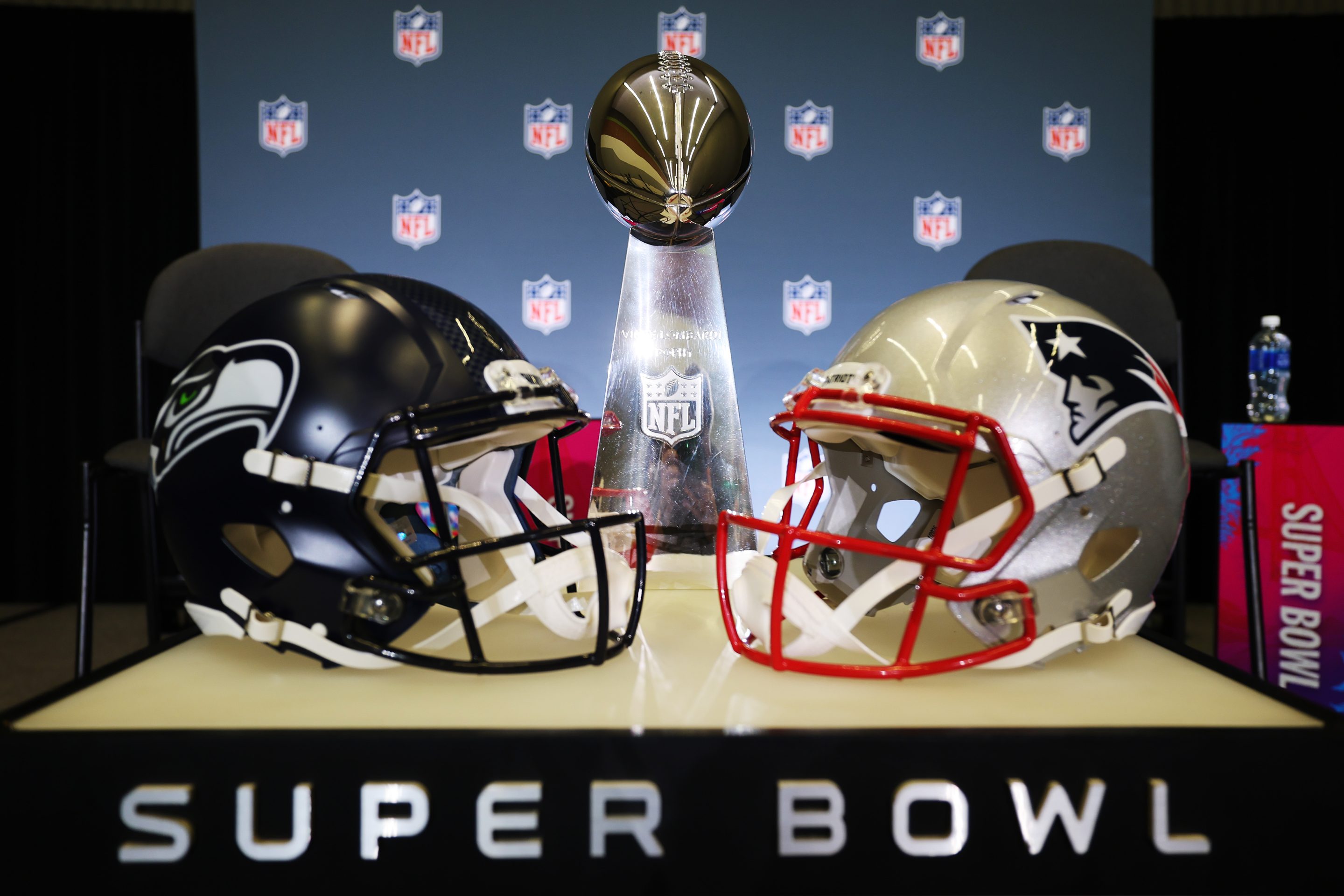 The Vince Lombardi Trophy is framed by the Seattle Seahawks and New England Patriots helmets during Super Bowl LX Opening Night at San Jose McEnery Convention Center on February 02, 2026 in San Jose, California.