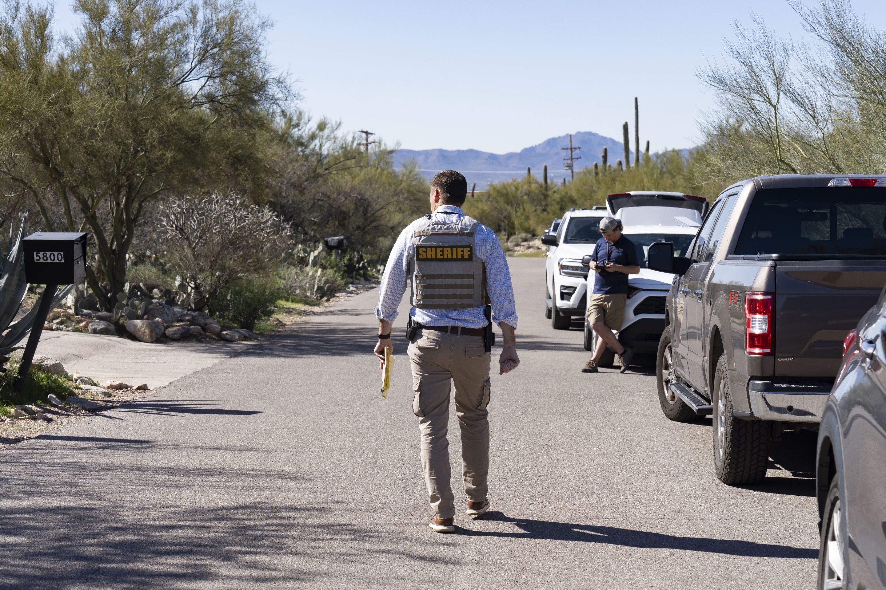 man in sheriff uniform patrols neighborhood