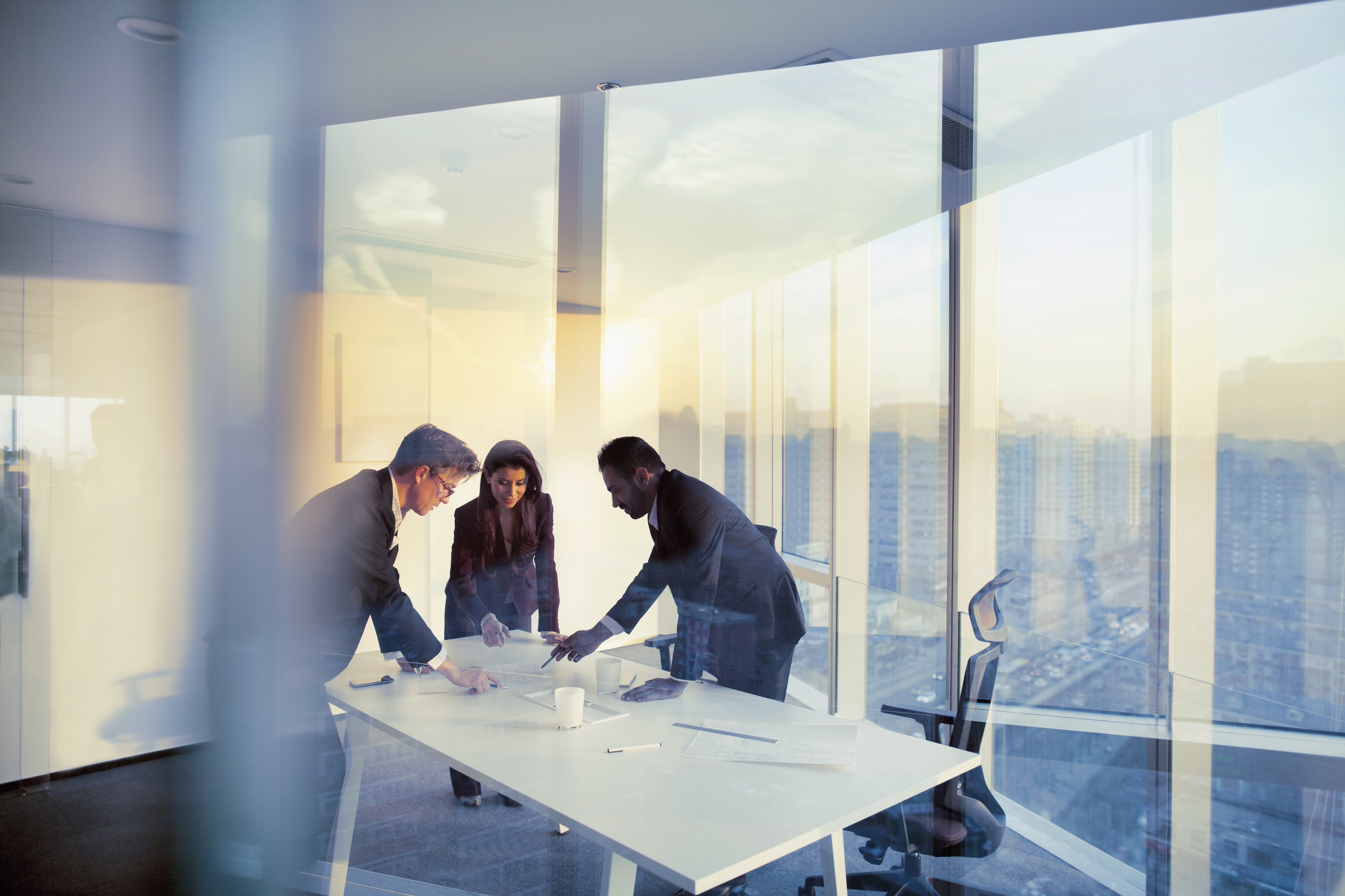 Adult, senior, diverse executive team business people together in conference meeting room in contemporary modern office bright sunny daylight sunset dusk talking discussing planning organizing strategy