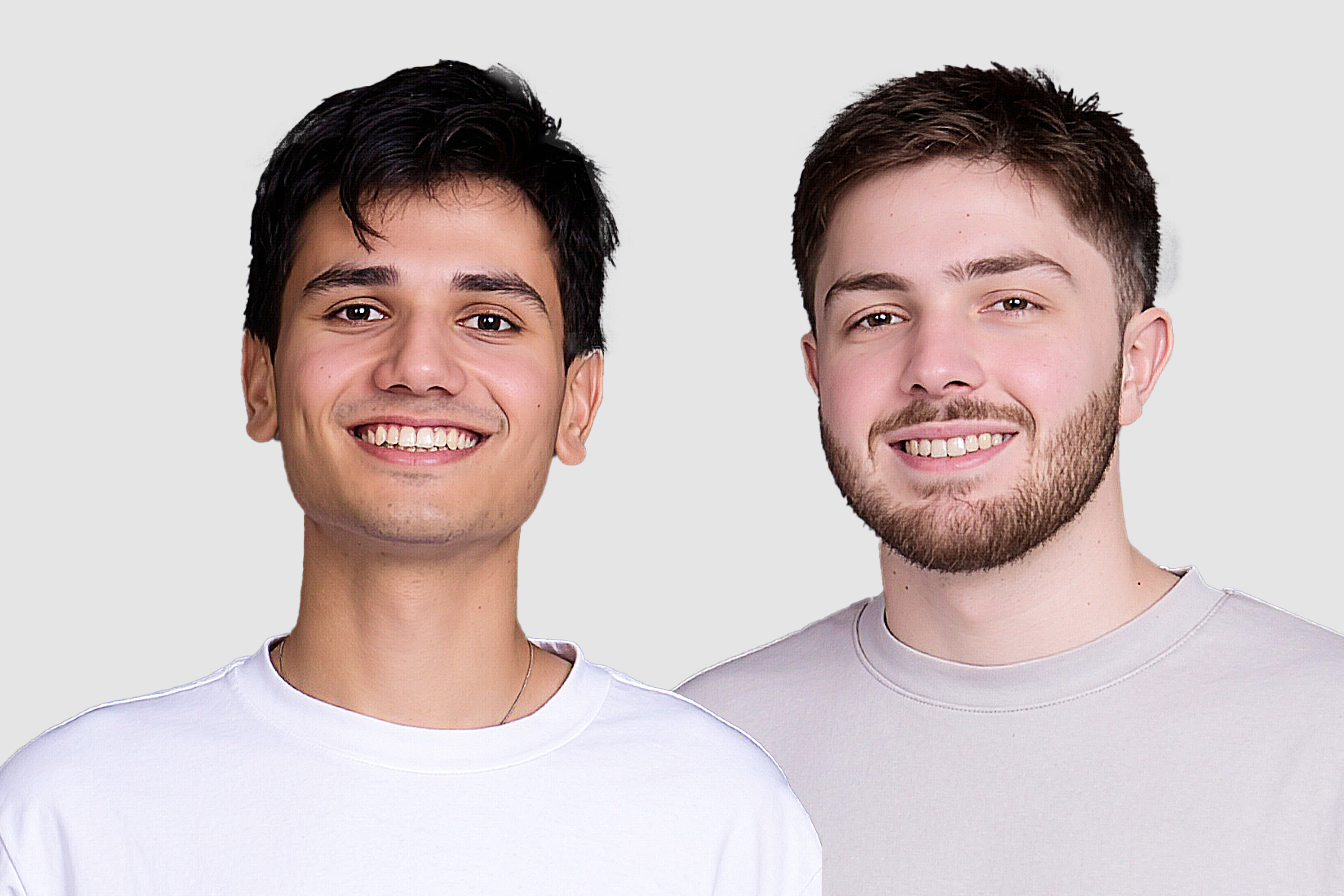 two men smile in front of the camera
