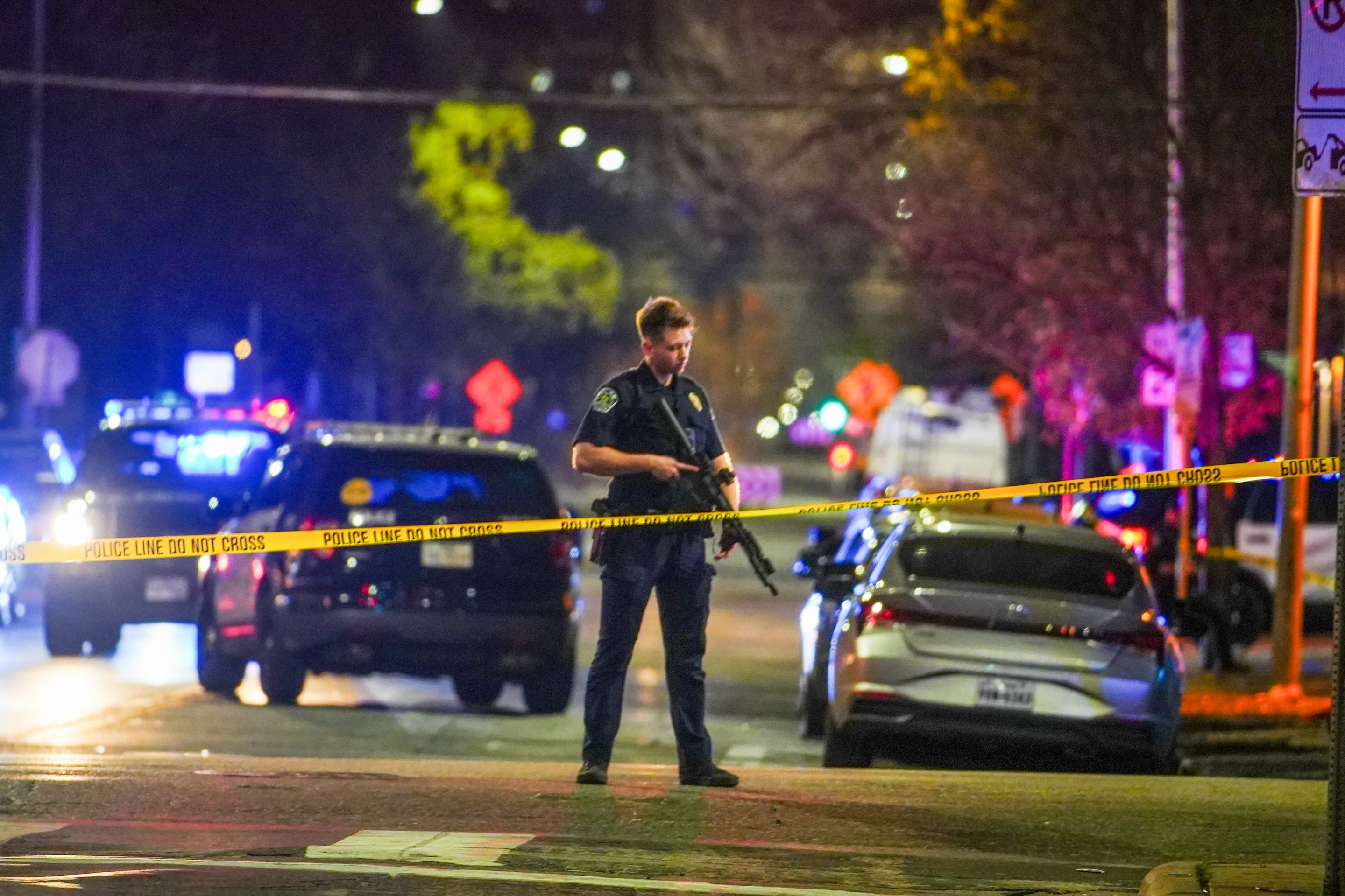 An Austin police officer guards the scene on West 6th Street at West Avenue after a shooting, Sunday March 1, 2026, in Austin, Texas.