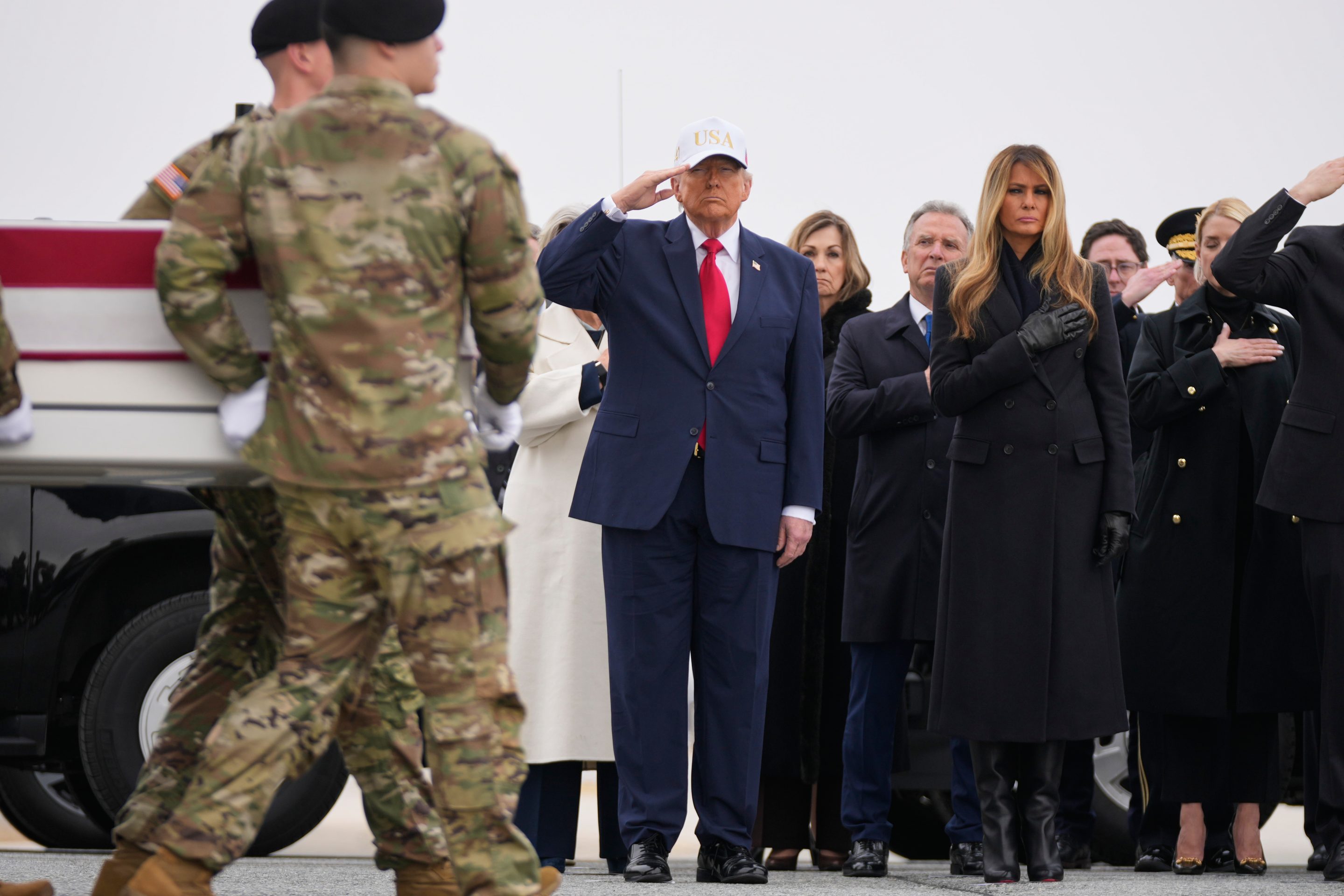 An Army carry team moves a flag-draped transfer case with the remains of U.S. Army Reserve soldier Sgt. 1st Class Nicole Amor, of White Bear Lake, Minn., who was killed in a drone strike at a command center in Kuwait after the U.S. and Israel launched its military campaign against Iran, past President Donald Trump and first lady Melania Trump during a casualty return, Saturday, March 7, 2026, at Dover Air Force Base, Del.