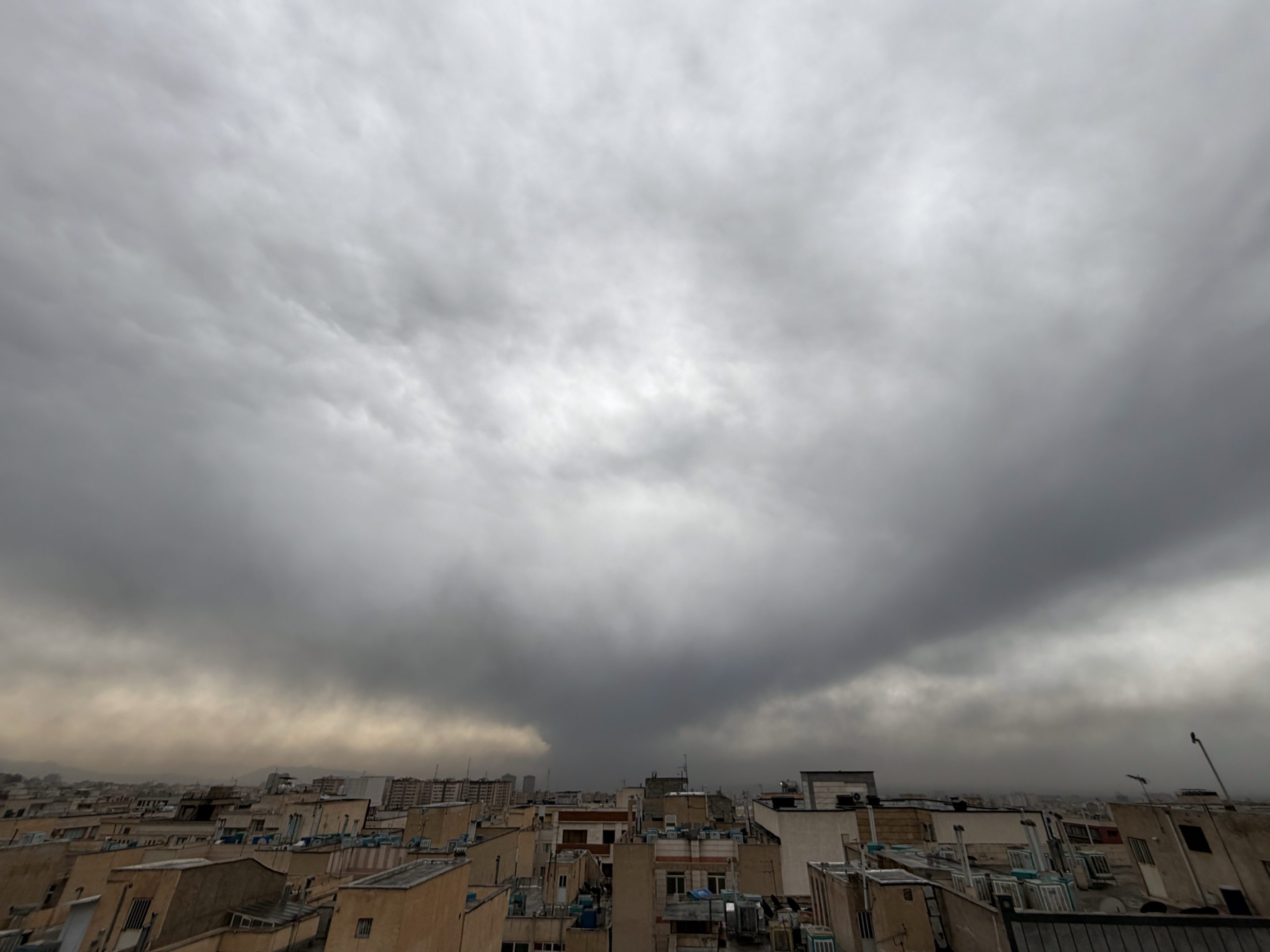 Plumes of smoke from a U.S.-Israeli strike on an oil facility late Saturday linger and merge with the cloudy sky over Tehran, Iran, Sunday, March 8, 2026.