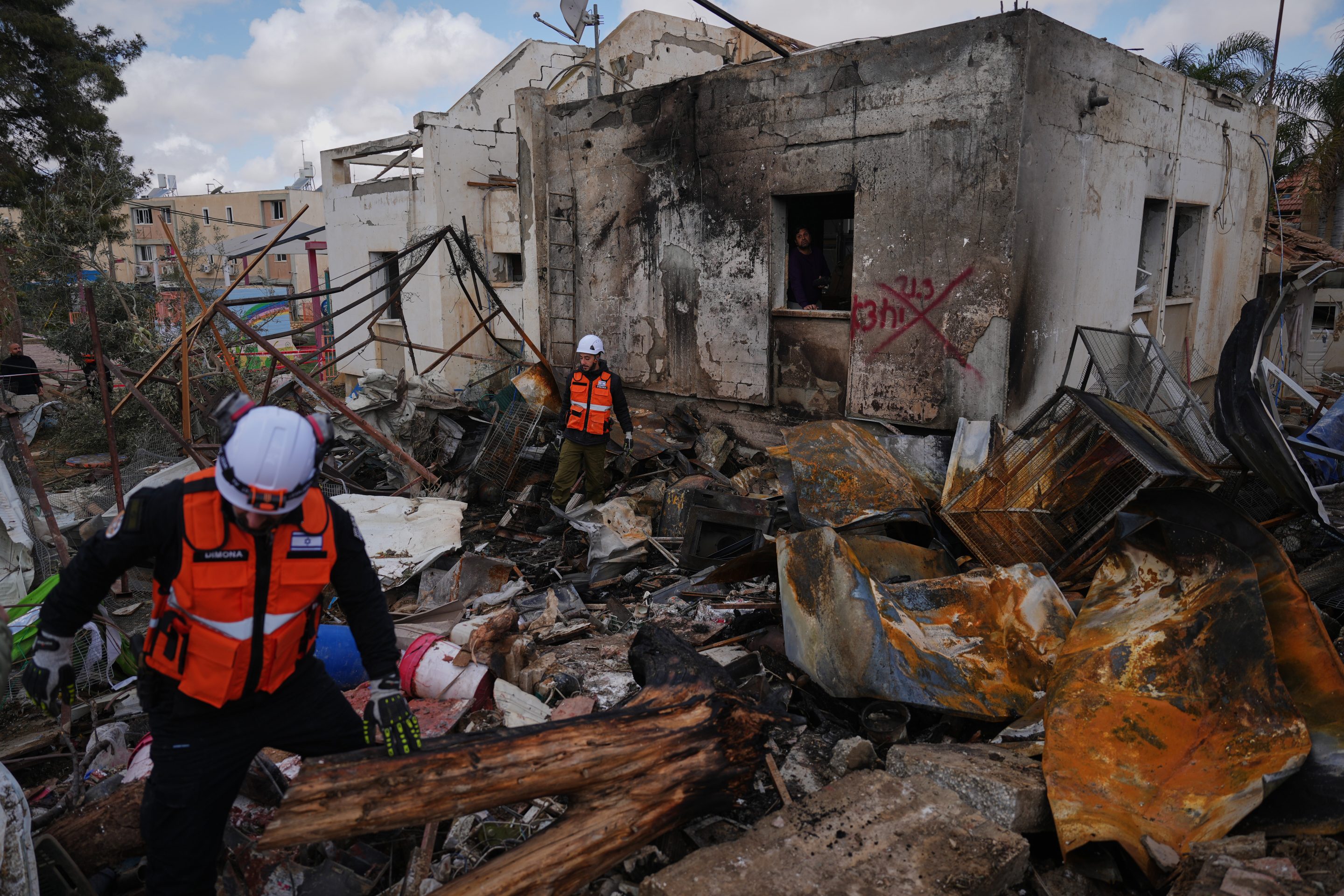 Israeli security forces survey the site that was struck by an Iranian missile in Dimona, southern Israel, Sunday, March 22, 2026.