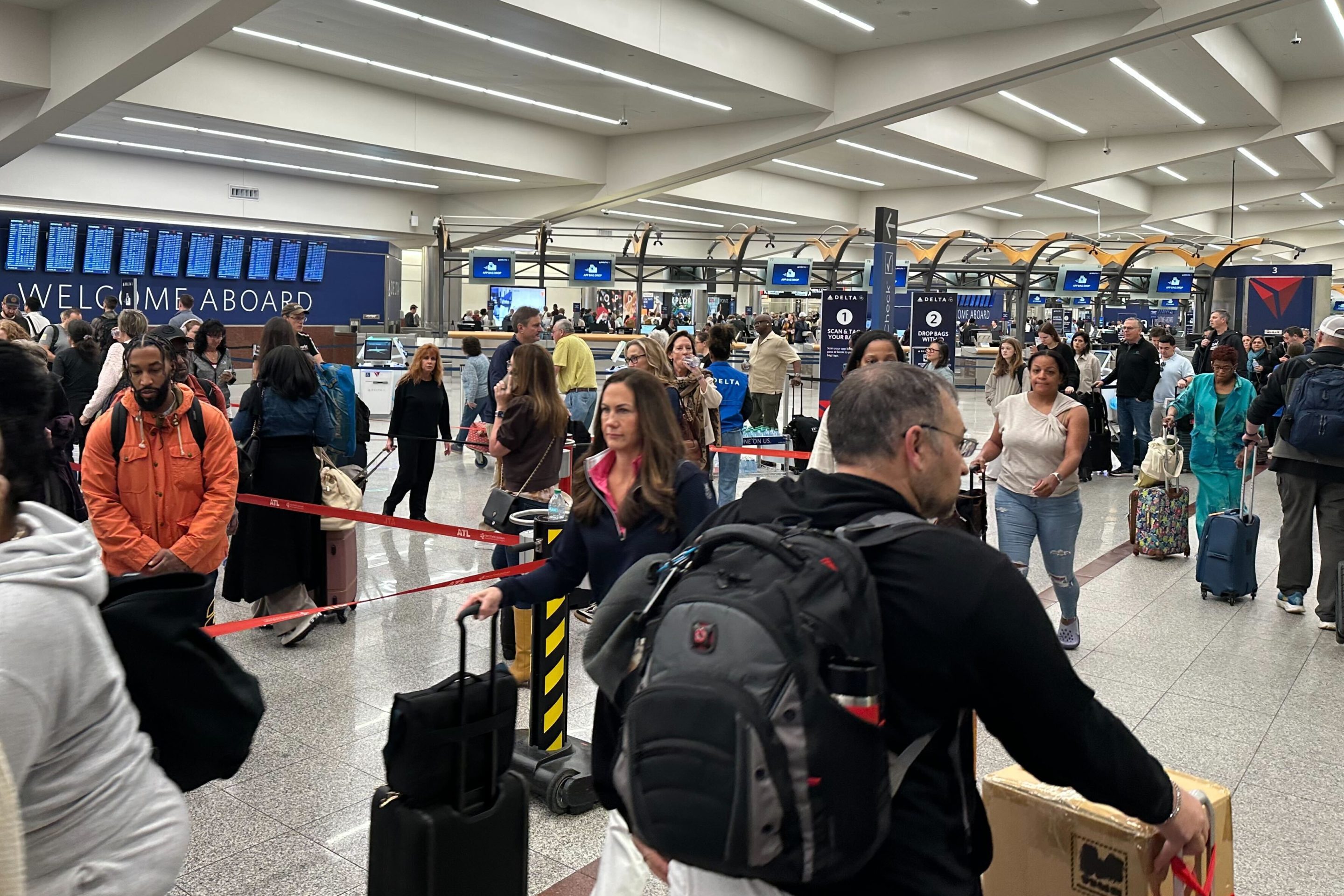 Travelers stand in a TSA checkpoint line at Hartsfield–Jackson Atlanta International Airport on Friday, March 27, 2026.
