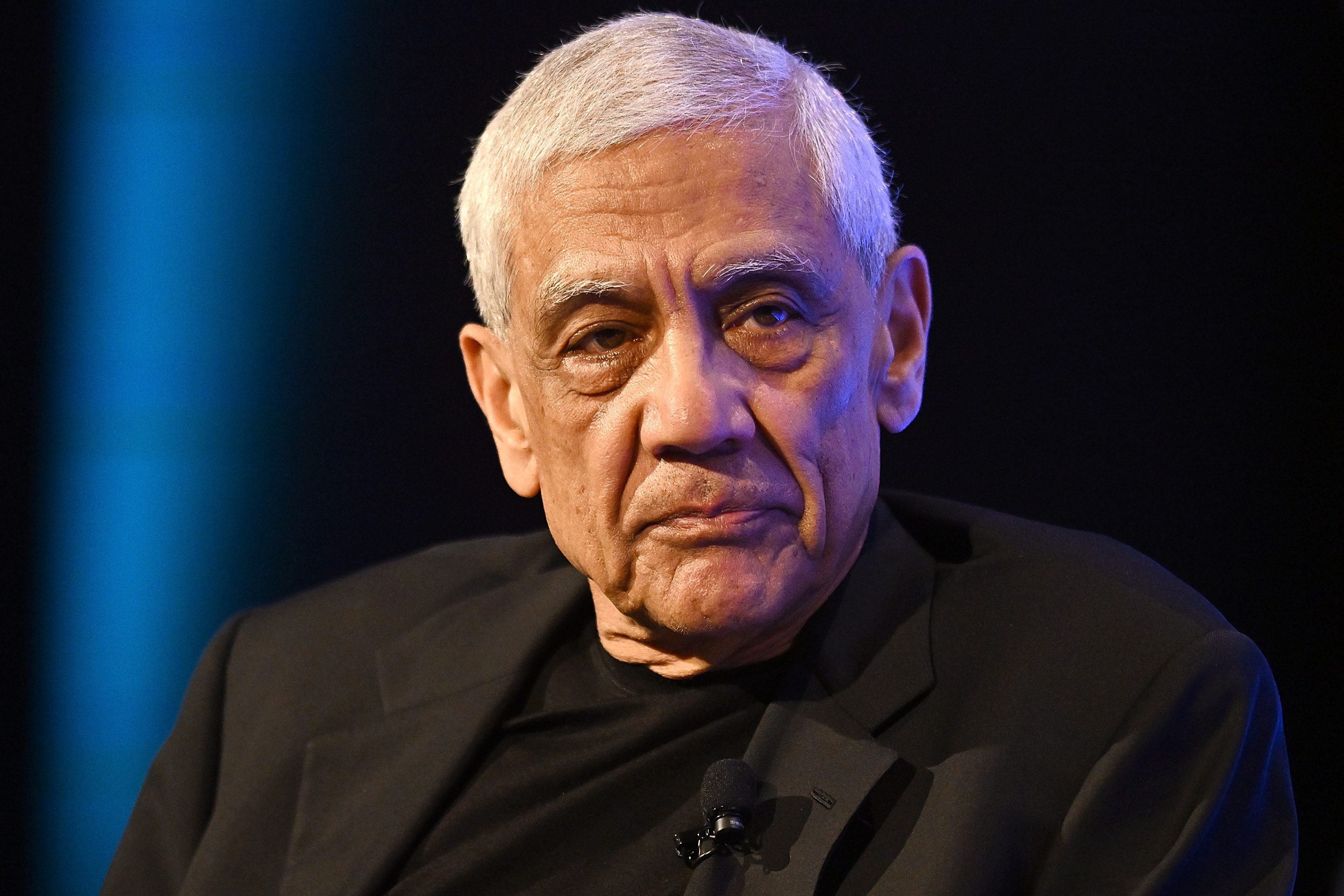 Vinod Khosla, wearing a black suit jacket, looks forward.