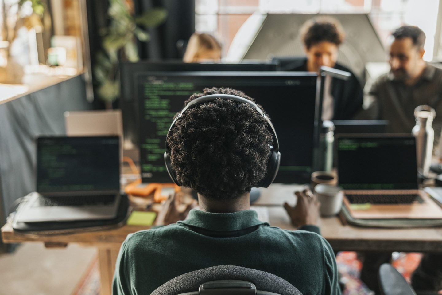 Software engineer sat at a desk looking at a screen.