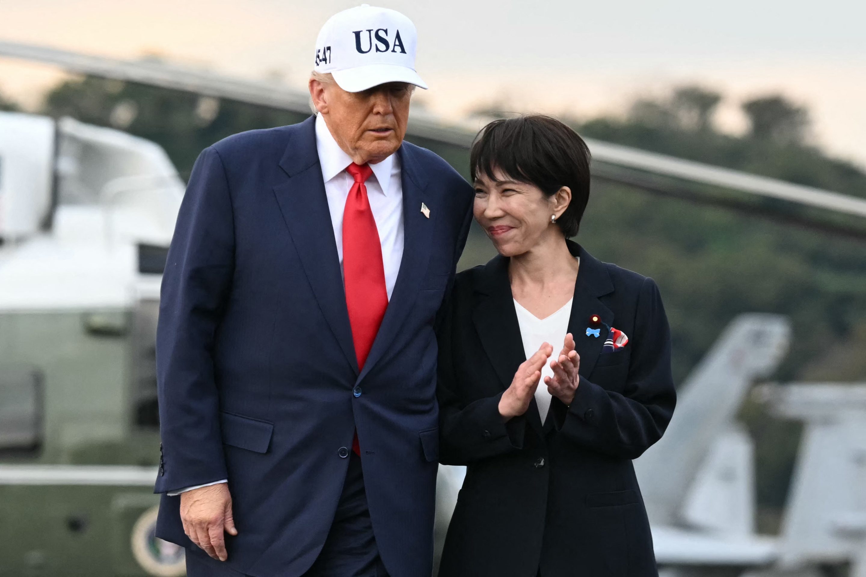 US President Donald Trump (L) and Japan's Prime Minister Sanae Takaichi arrive on board the US Navy's USS George Washington aircraft carrier at the US naval base in Yokosuka on October 28, 2025. 