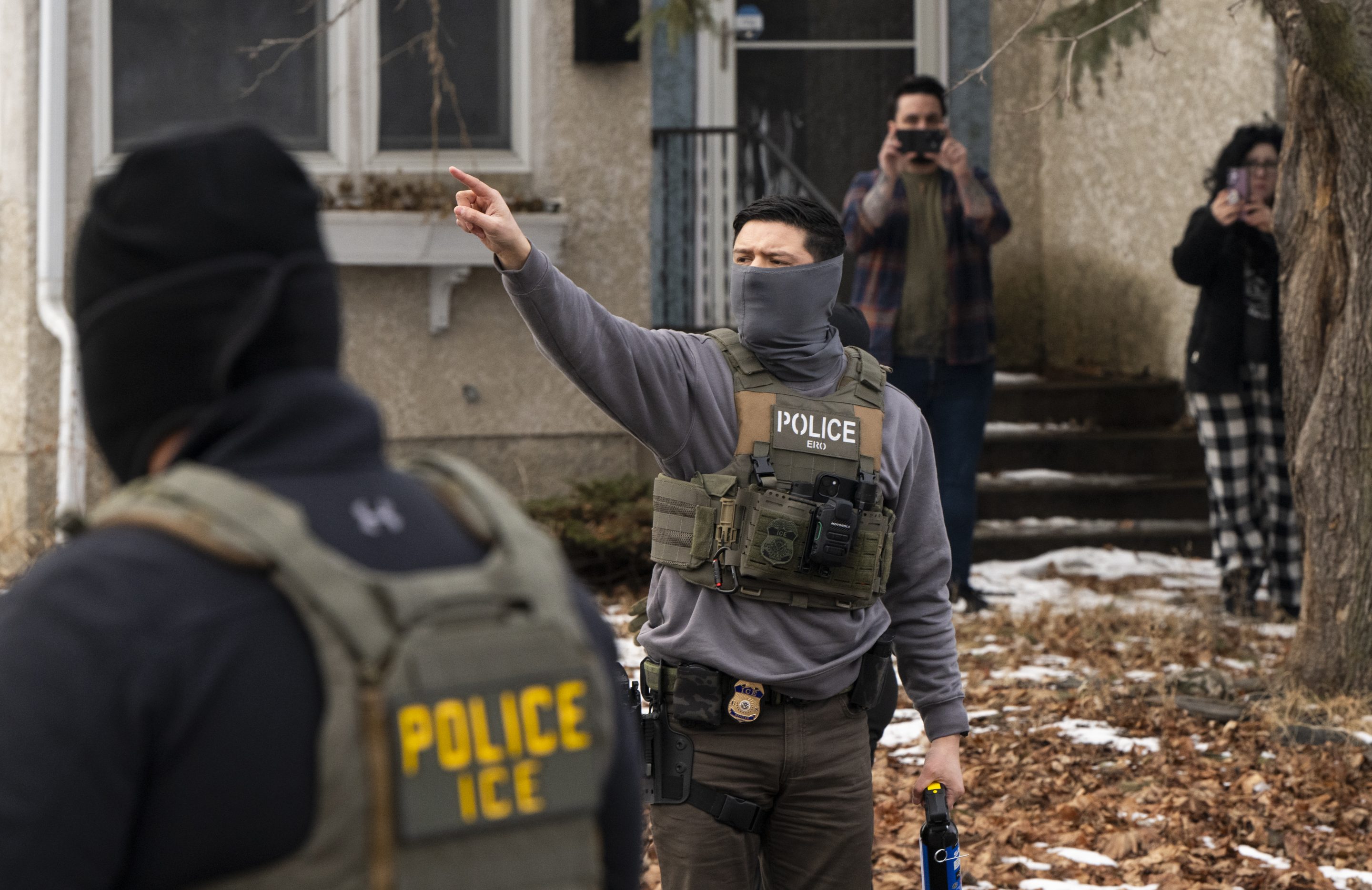 Observers film ICE agents as they hold a perimeter after one of their vehicles got a flat tire on Penn Avenue on February 5, 2026 in Minneapolis, Minnesota.