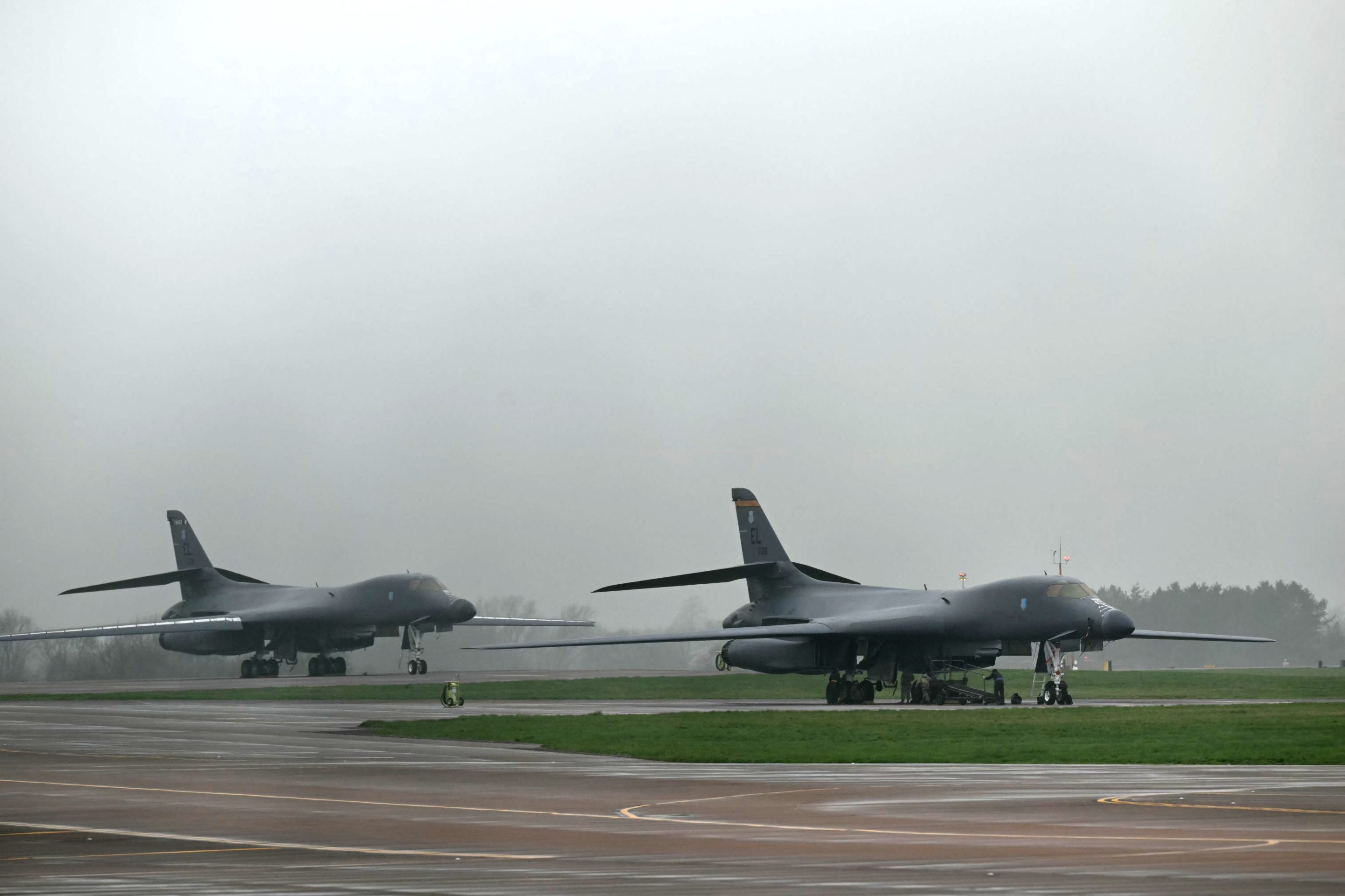 A US Air Force B-1 Lancer bomber is worked on by military personnel at RAF Fairford in south west England shortly after sunrise on March 7, 2026.