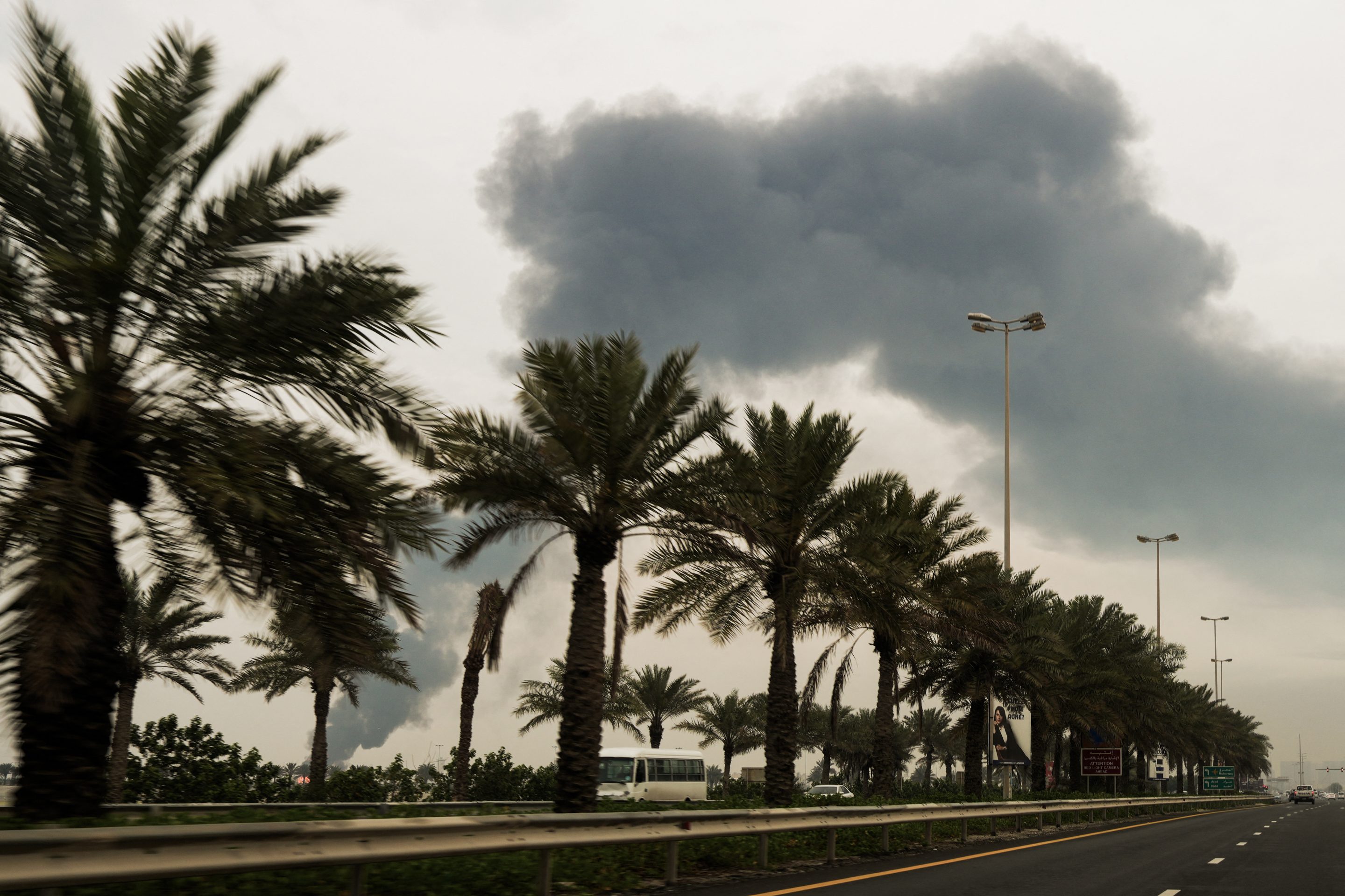 A plume of smoke rises after a reported Iranian strike on fuel tanks in Muharraq on March 12, 2026.