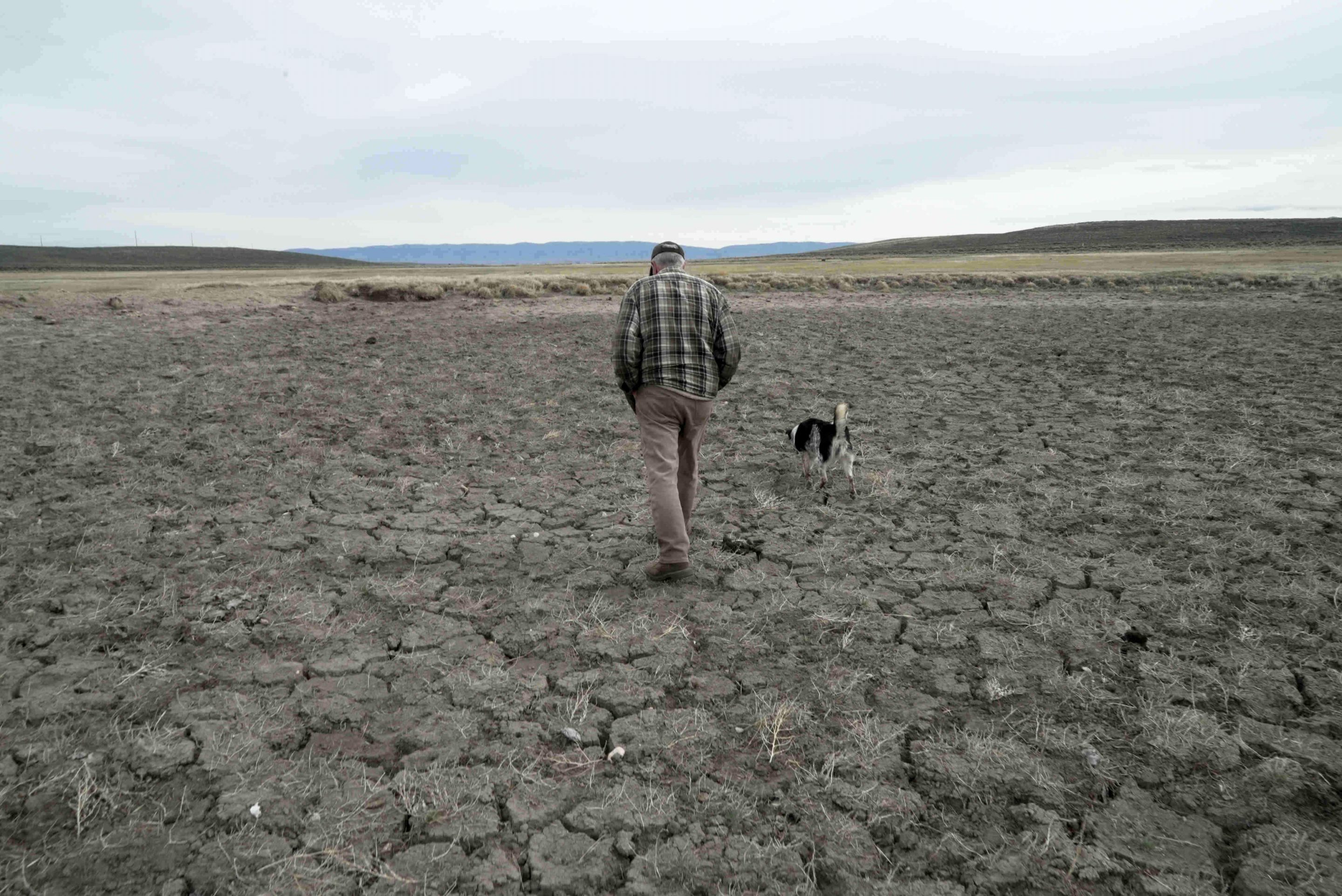 Philip Anderson walks across a dry stock pond March 31, 2026, in Walden, Colo.