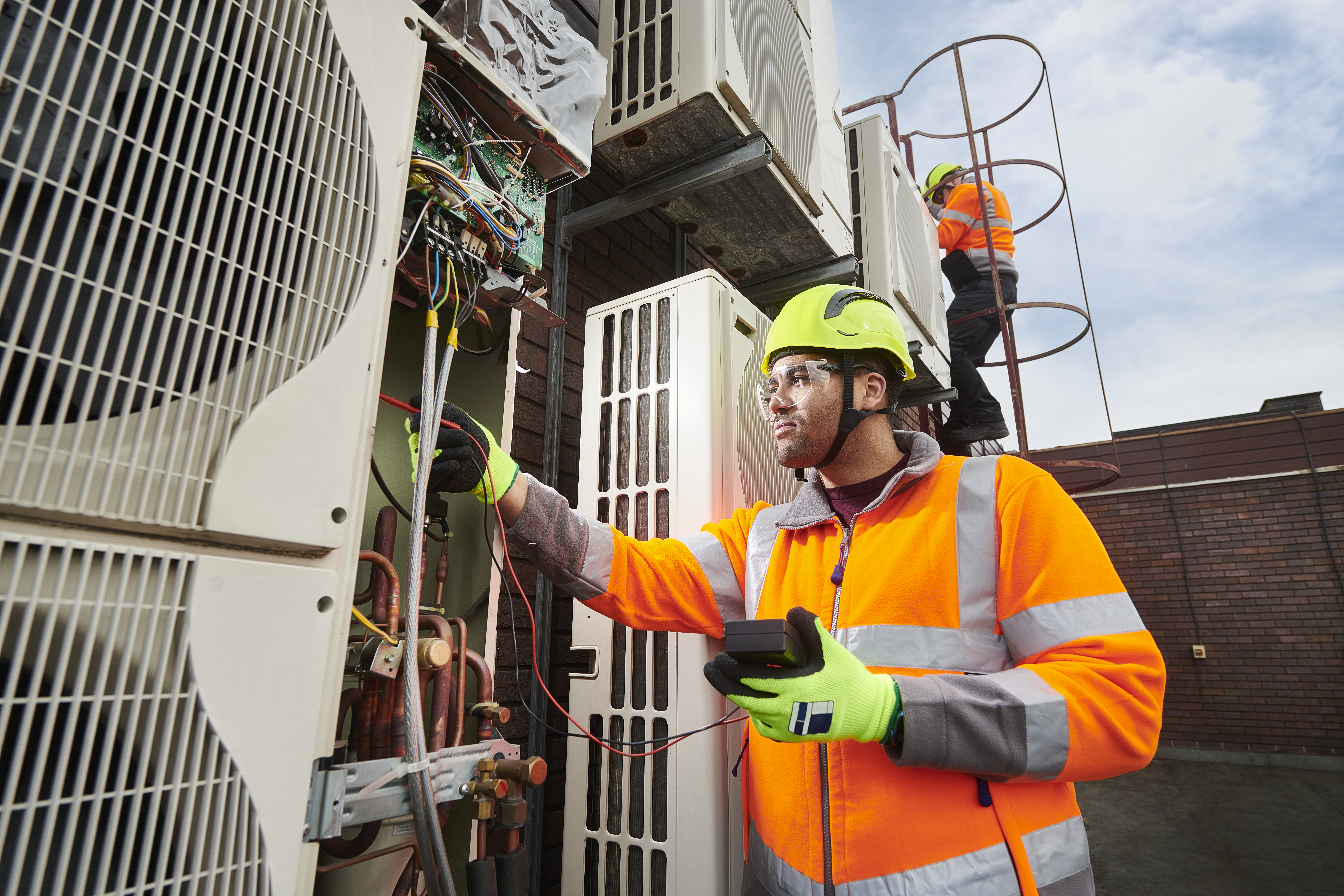 maintenance engineers servicing air conditioning units