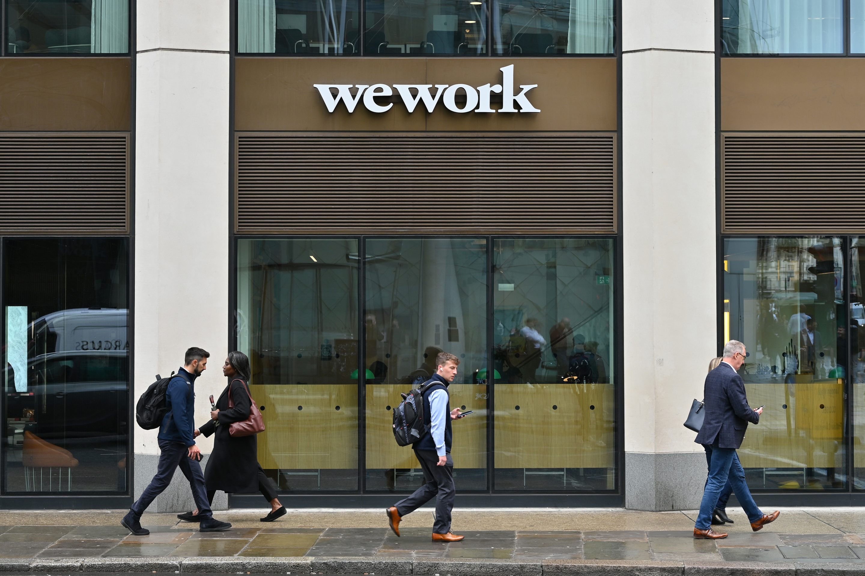 People walk past a Wework office building in Moorgate on June 3, 2025 in London, United Kingdom.