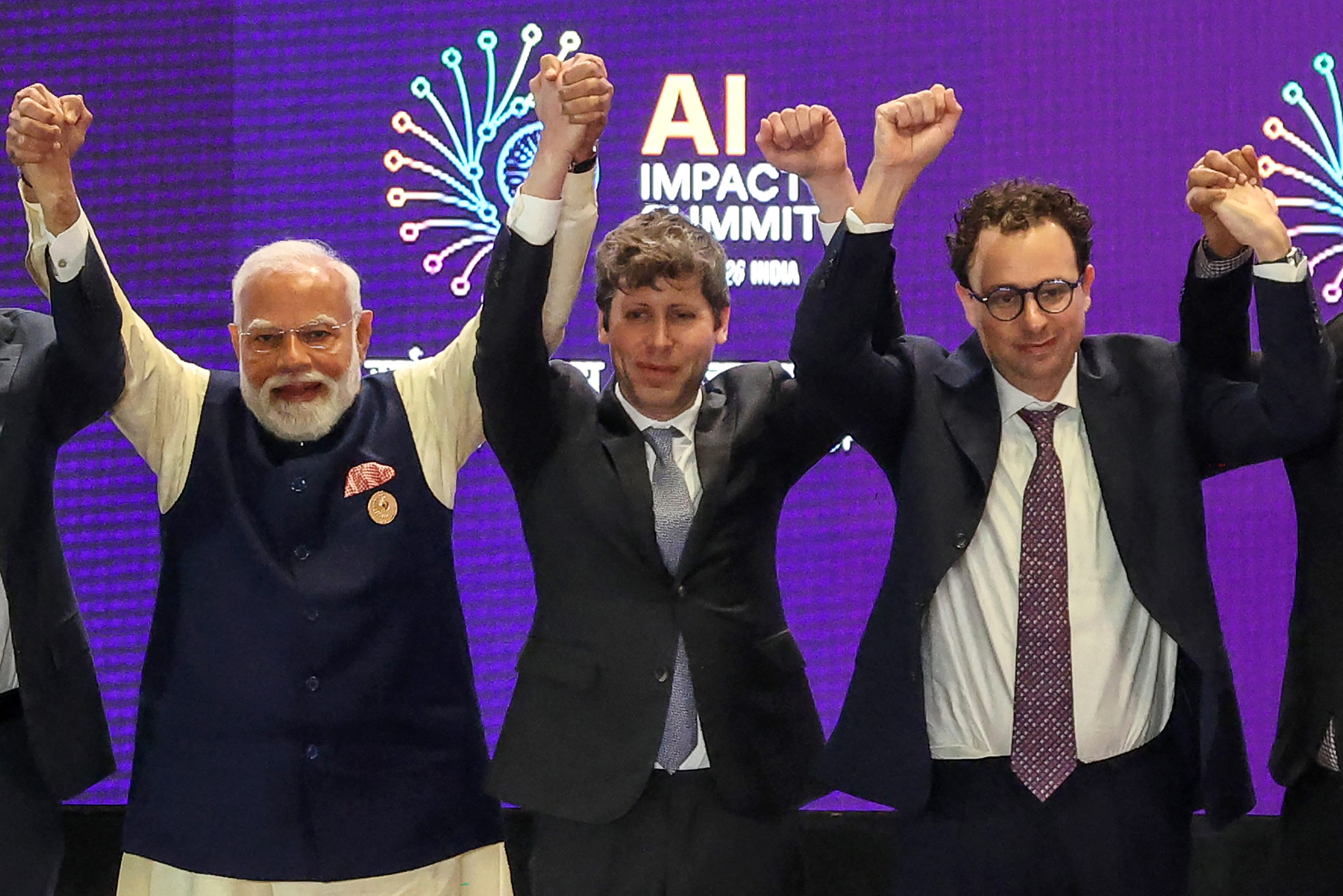 From left to right: Narendra Modi, Sam Altman, and Dario Amodei