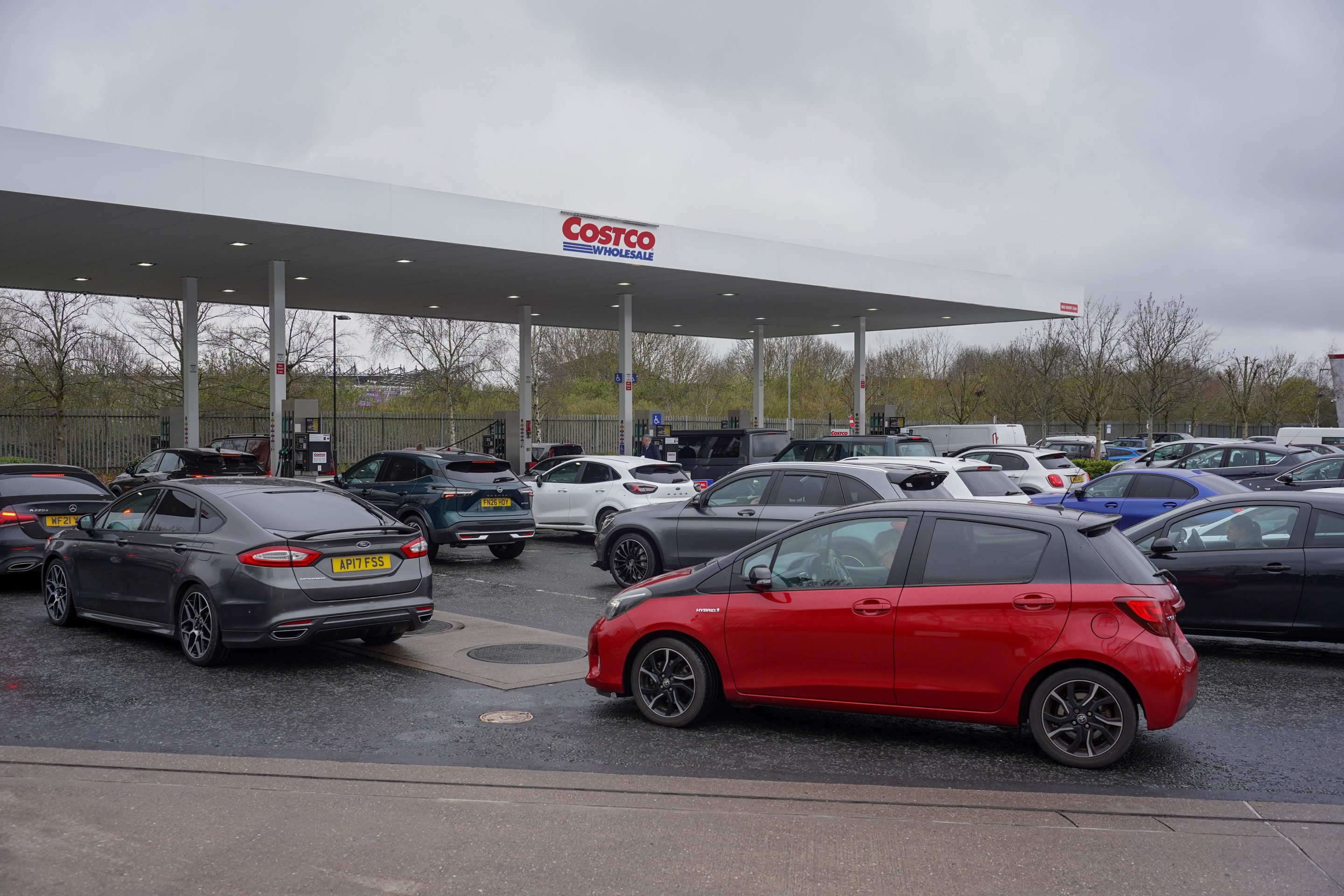 Motorists fill their cars at a Costco Petrol station in Derby, U.K., March 27, 2026.