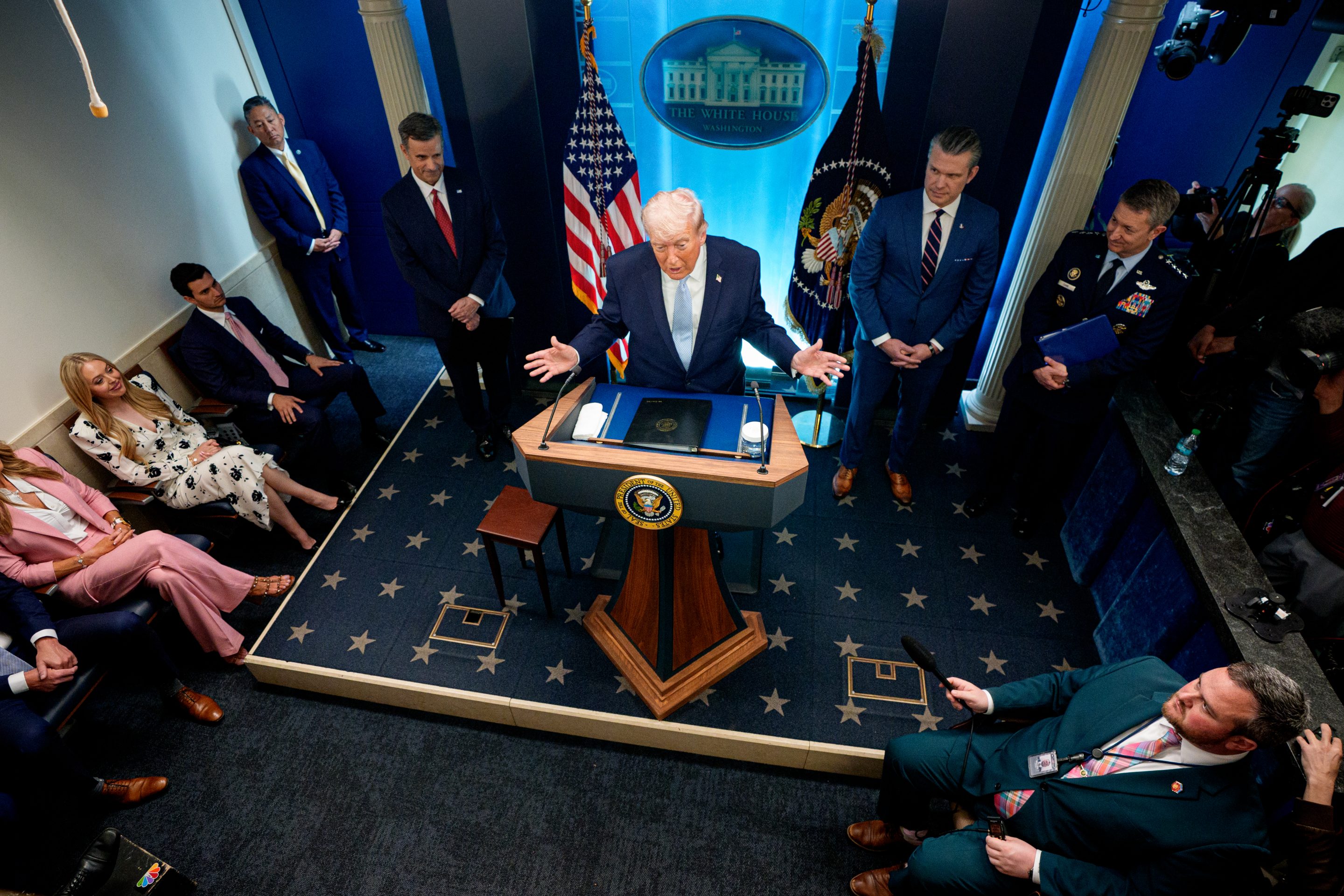 U.S. President Donald Trump, accompanied by CIA Director John Ratcliffe (C-L), Secretary of War Pete Hegseth (2nd-R) and Chairman of the Joint Chiefs of Staff General Dan Caine (R), speaks during a news conference at the White House on April 6, 2026.
