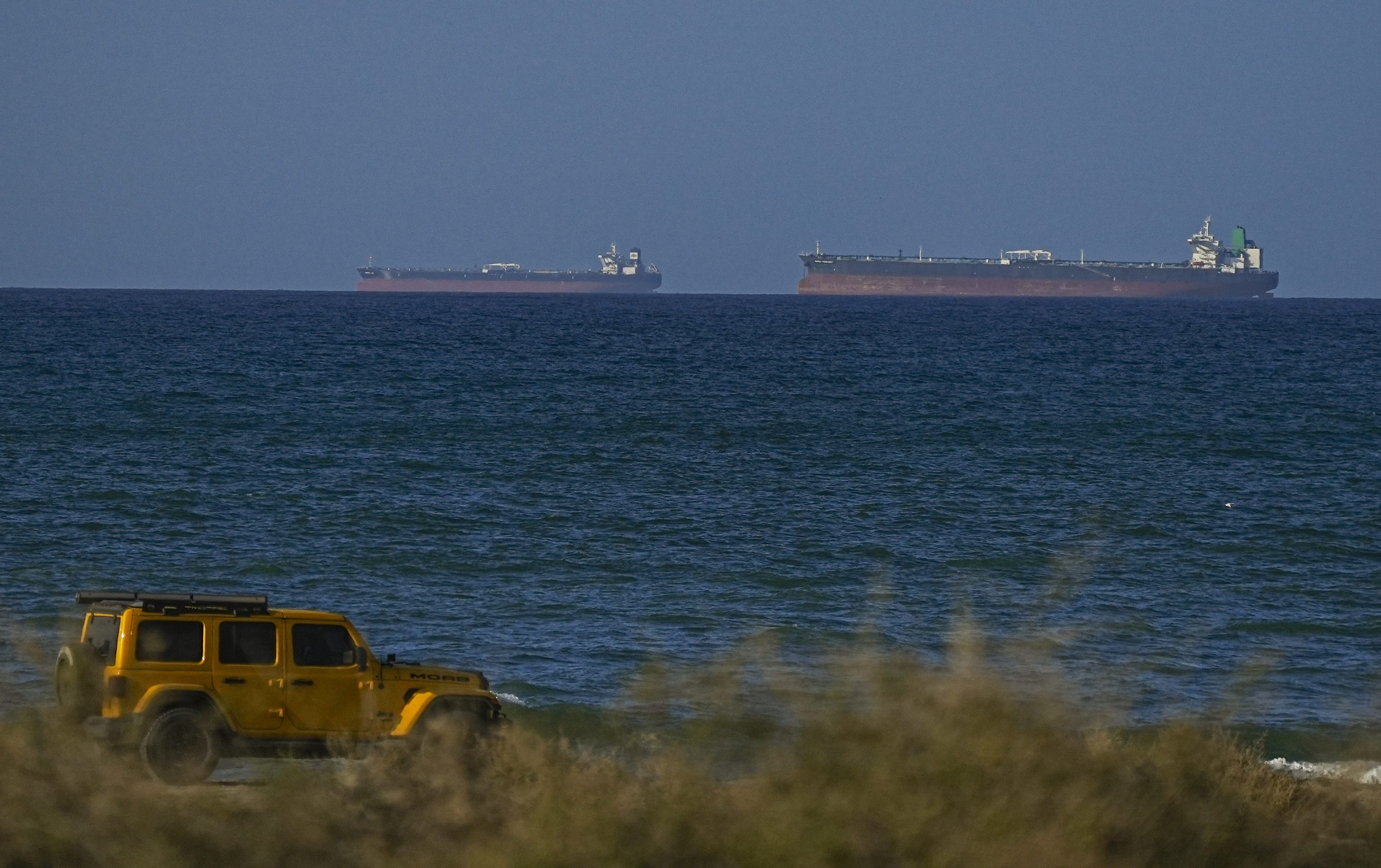 A view of the vessels passing through Strait of Hormuz following the two-week temporary ceasefire reached between the United States and Iran on the condition that the strait be reopened, seen in Oman on April 8, 2026.