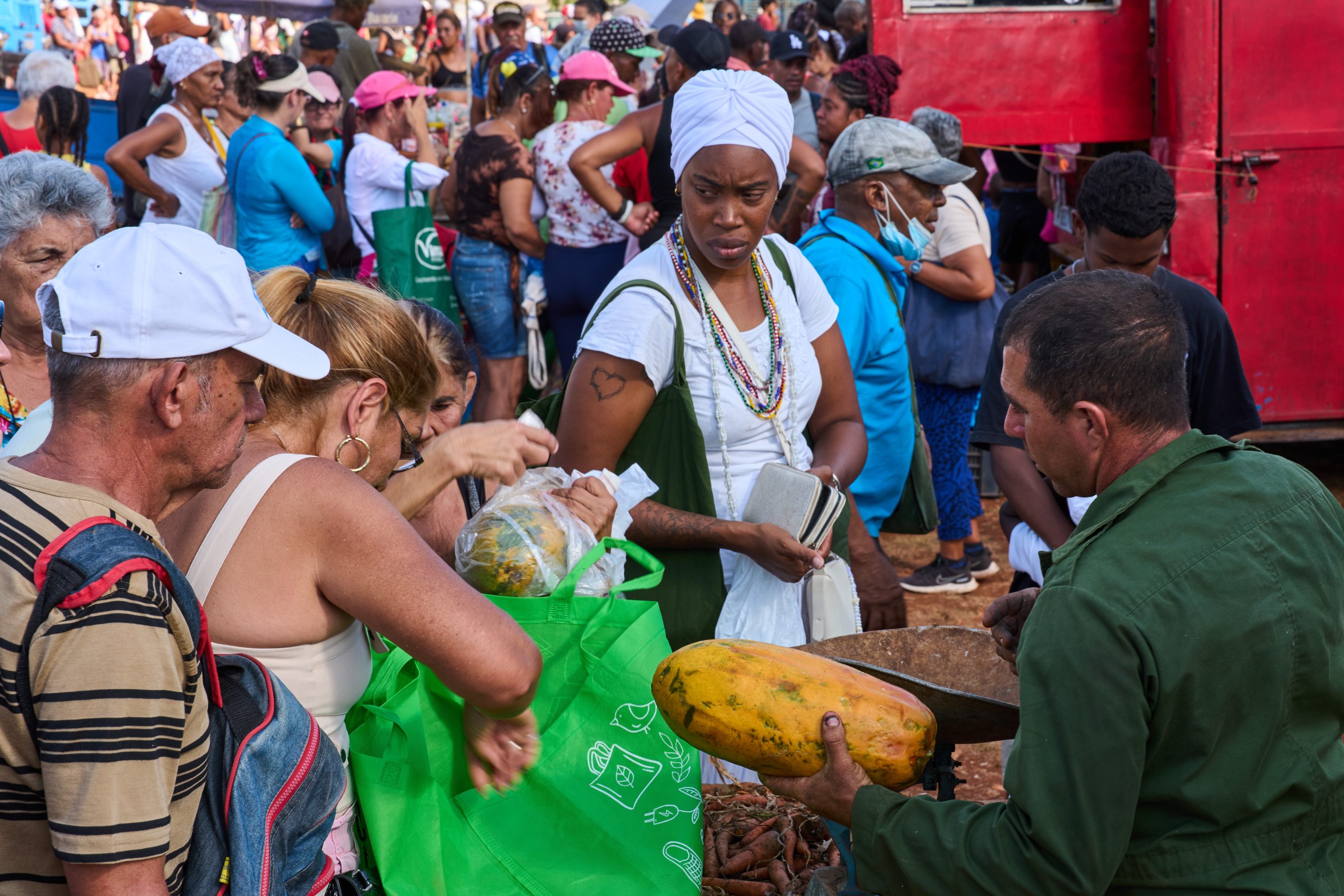 People line up to buy papaya at a weekly food fair in Alamar, Havana province, Cuba, Saturday, May 2, 2026.