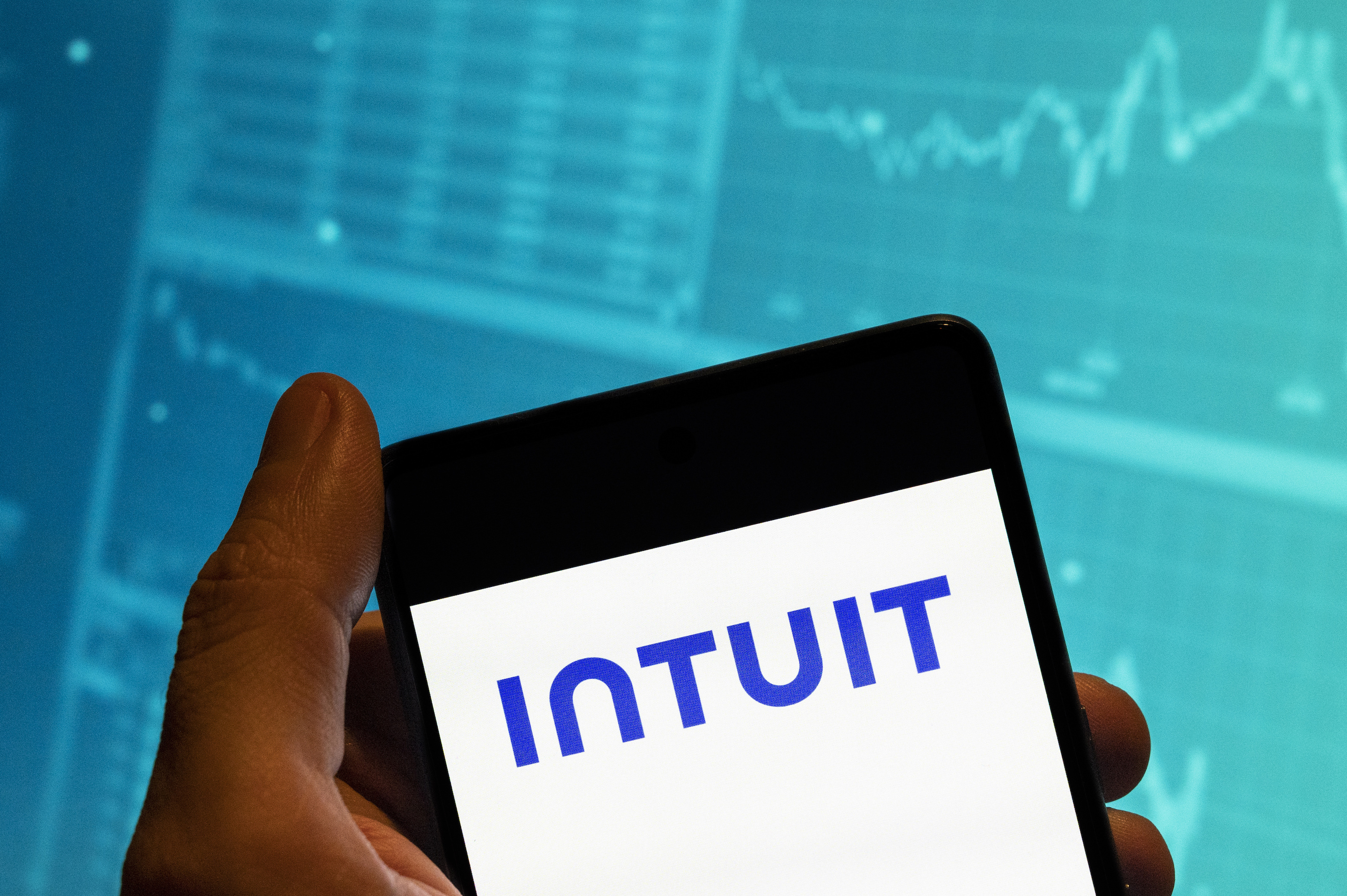 Intuit CFO Sandeep Aujla says the company is flattening management layers and reorganizing around AI, speed, and long-term growth.