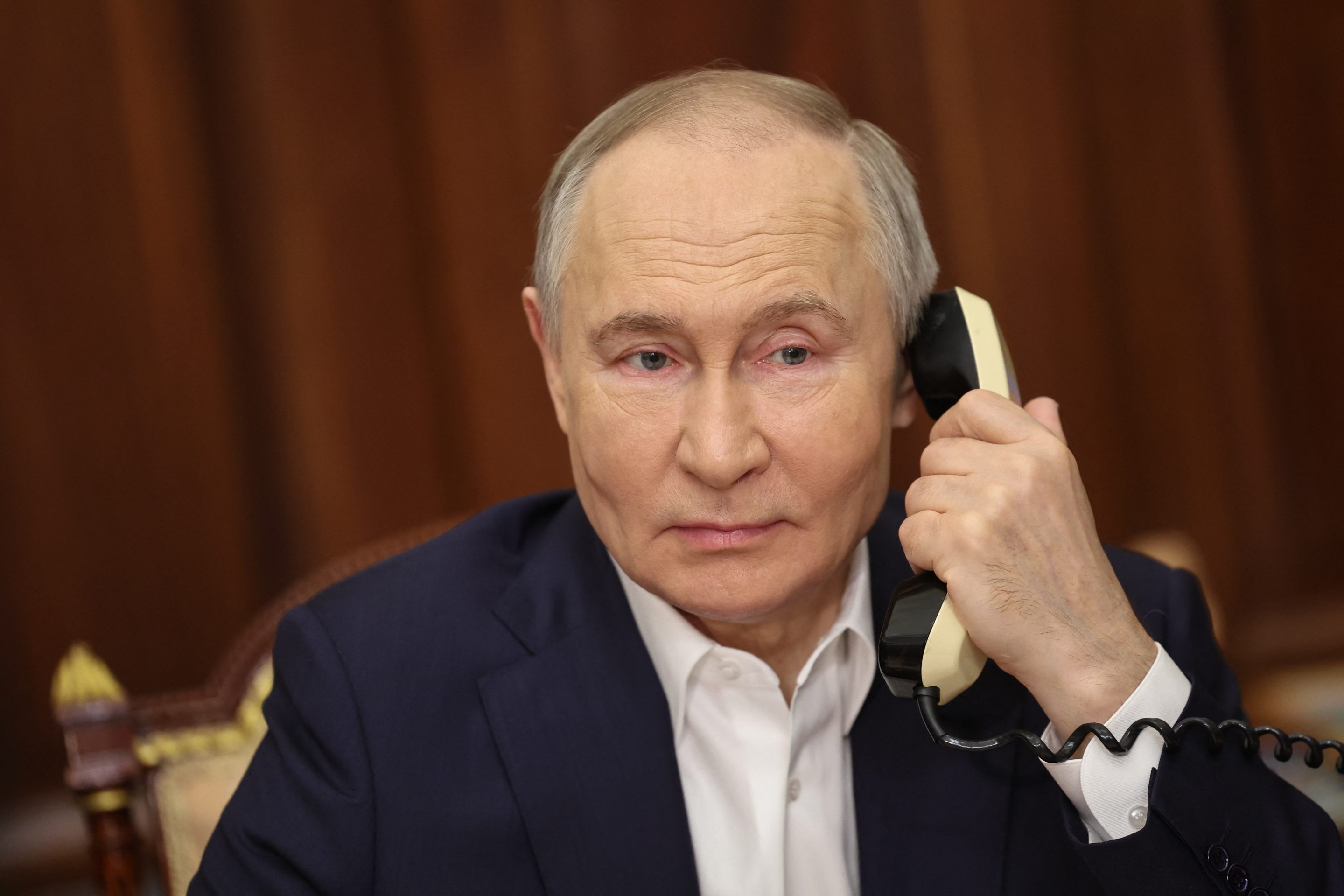 Russia's President Vladimir Putin talks on the phone in Moscow on January 7, 2025. 