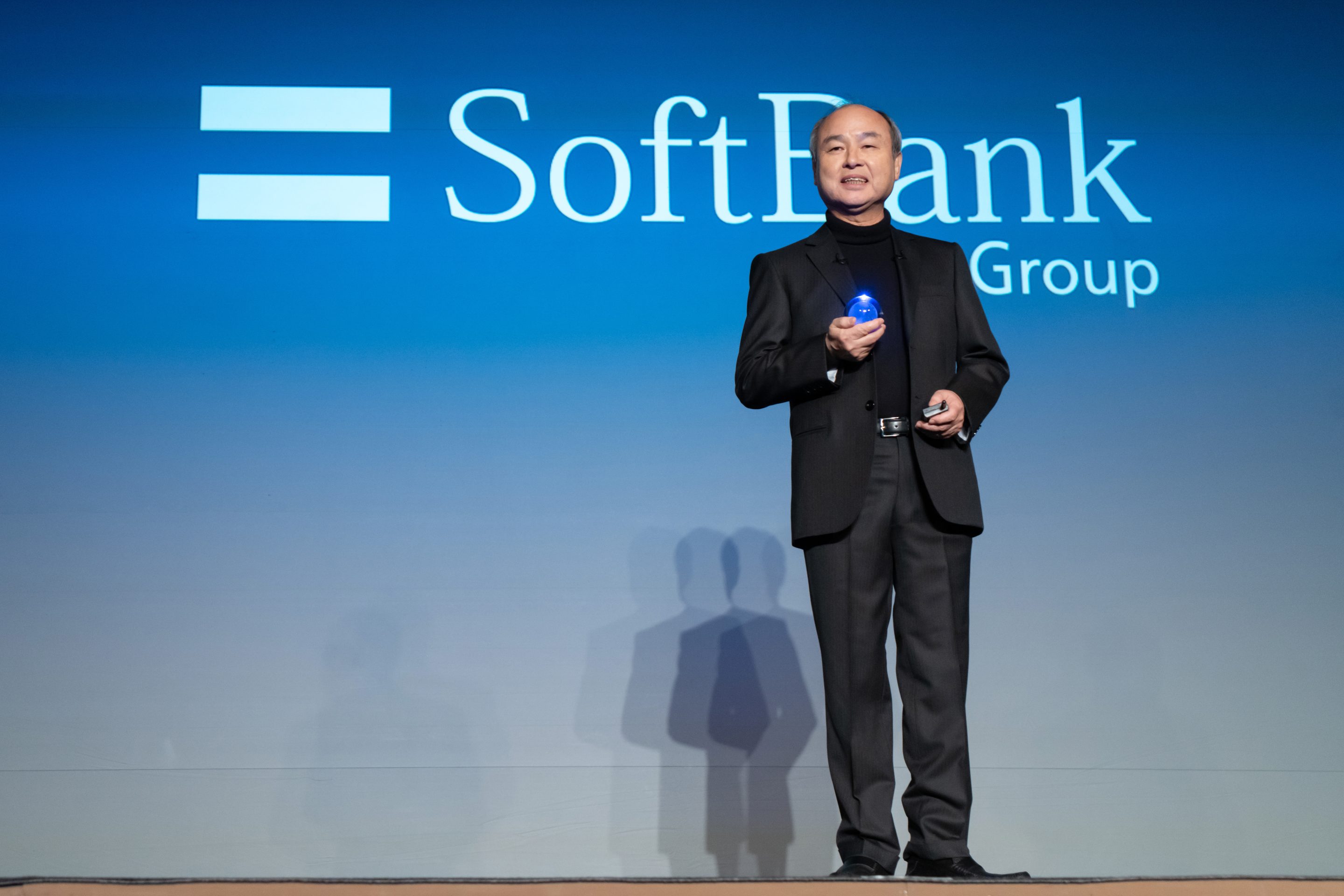 SoftBank Group CEO Masayoshi Son holds a crystal ball as he delivers a speech during an event titled "Transforming Business through AI" in Tokyo, Japan, on February 3, 2025.