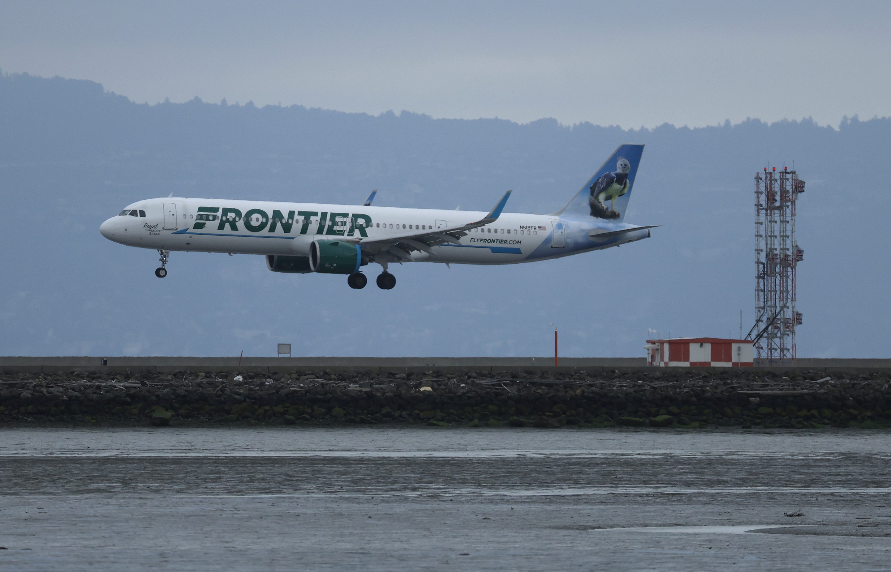 A Frontier Airlines plane lands at San Francisco International Airport on April 15, 2025.