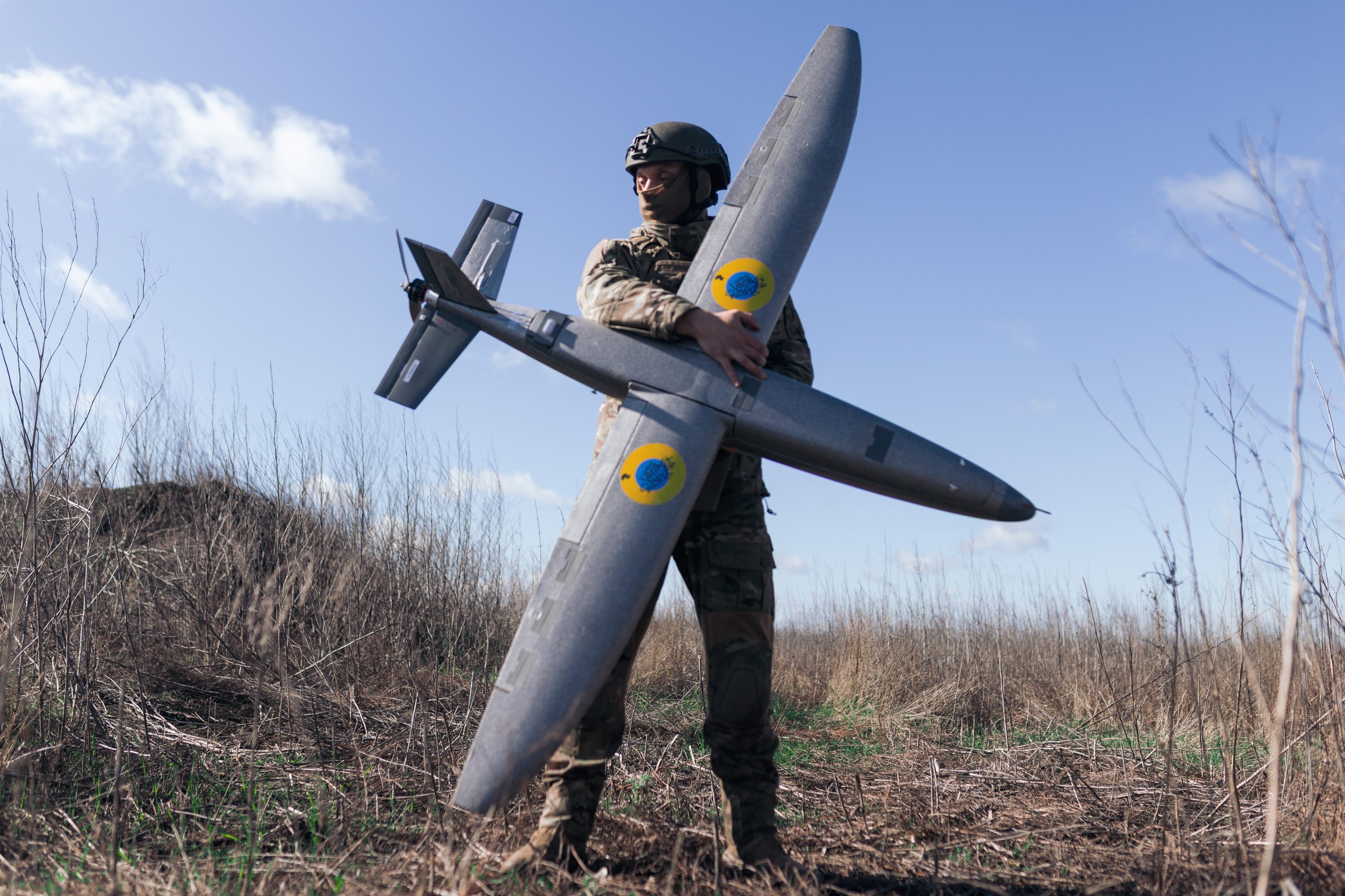 A portrait of a soldier from the Taiwan unmanned aerial vehicle unit holding a new model Marsianin attack drone on April 7, 2026 in Kharkiv region, Ukraine.