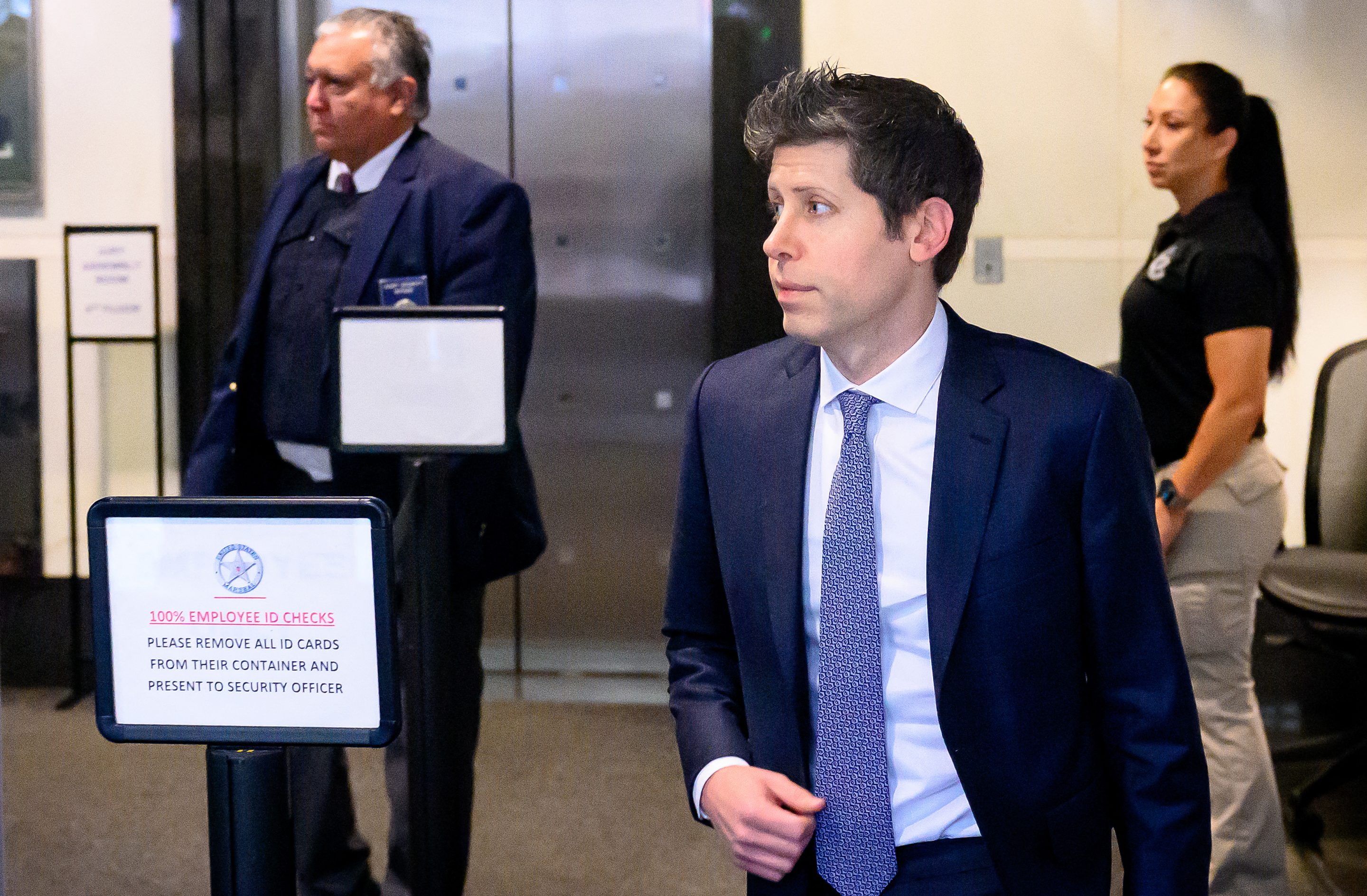 Sam Altman walks inside a courthouse