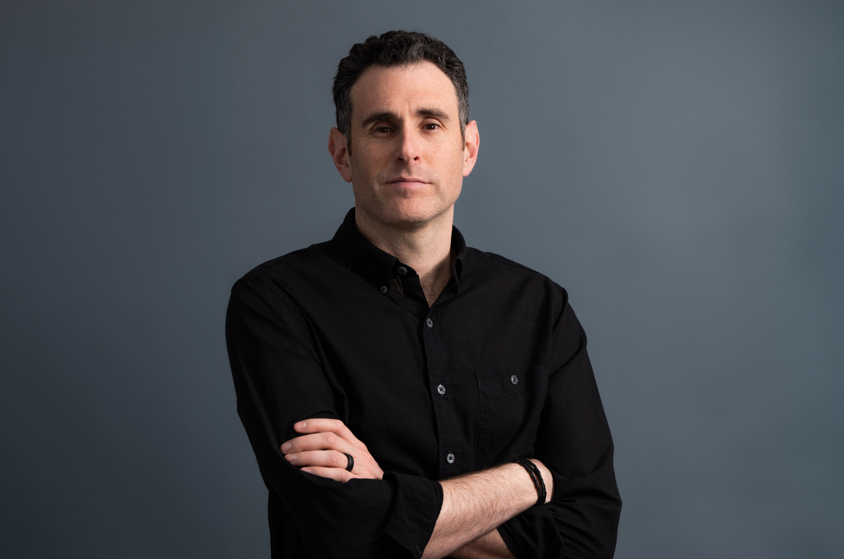Alex Israel crosses his arms