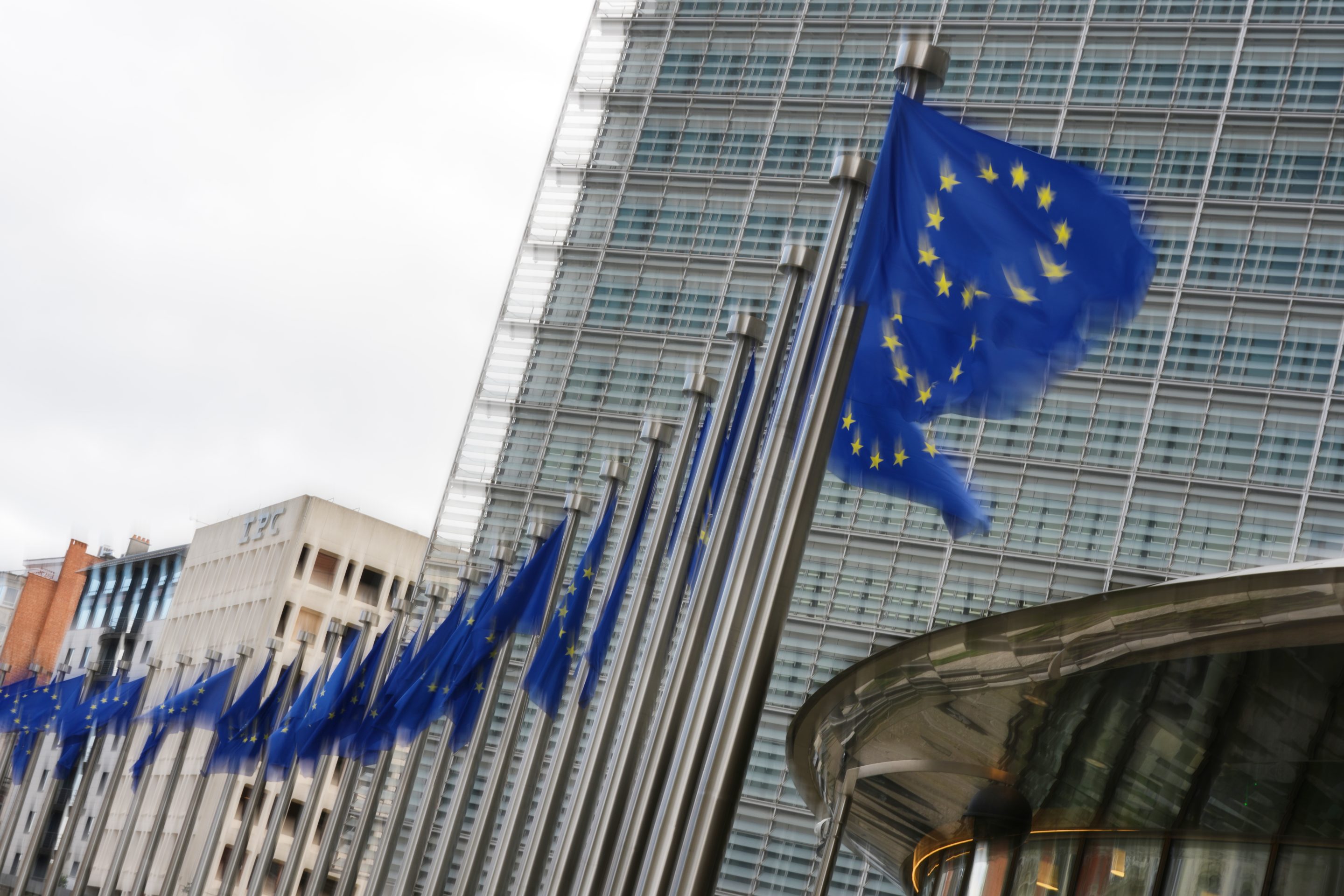 European Union flags flap in the wind outside EU headquarters in Brussels, Tuesday, May 12, 2026.
