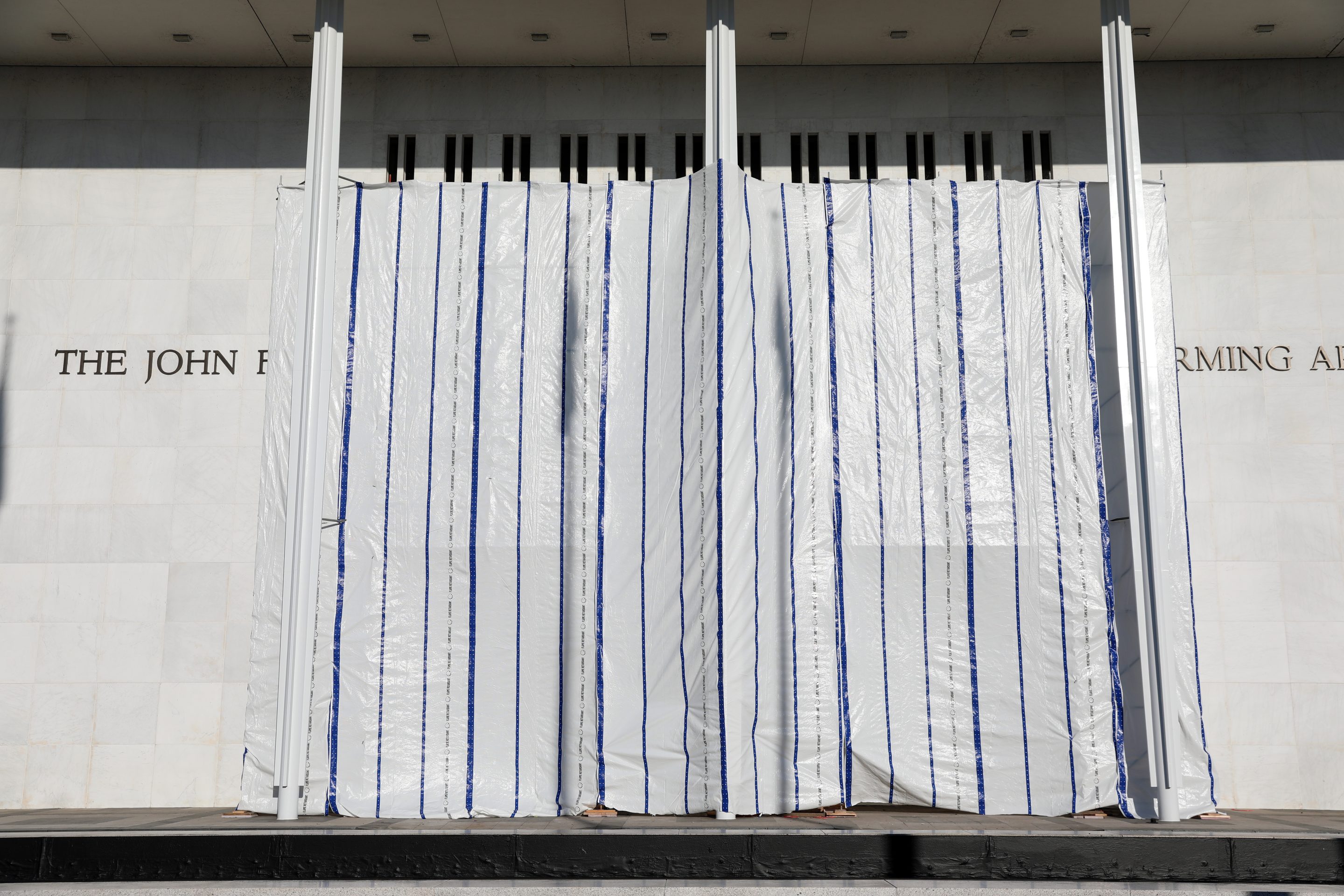 The wall of the John F. Kennedy Center for the Performing Arts is covered in tarp after President Donald Trump's name was removed, in Washington, Saturday, June 13, 2026.