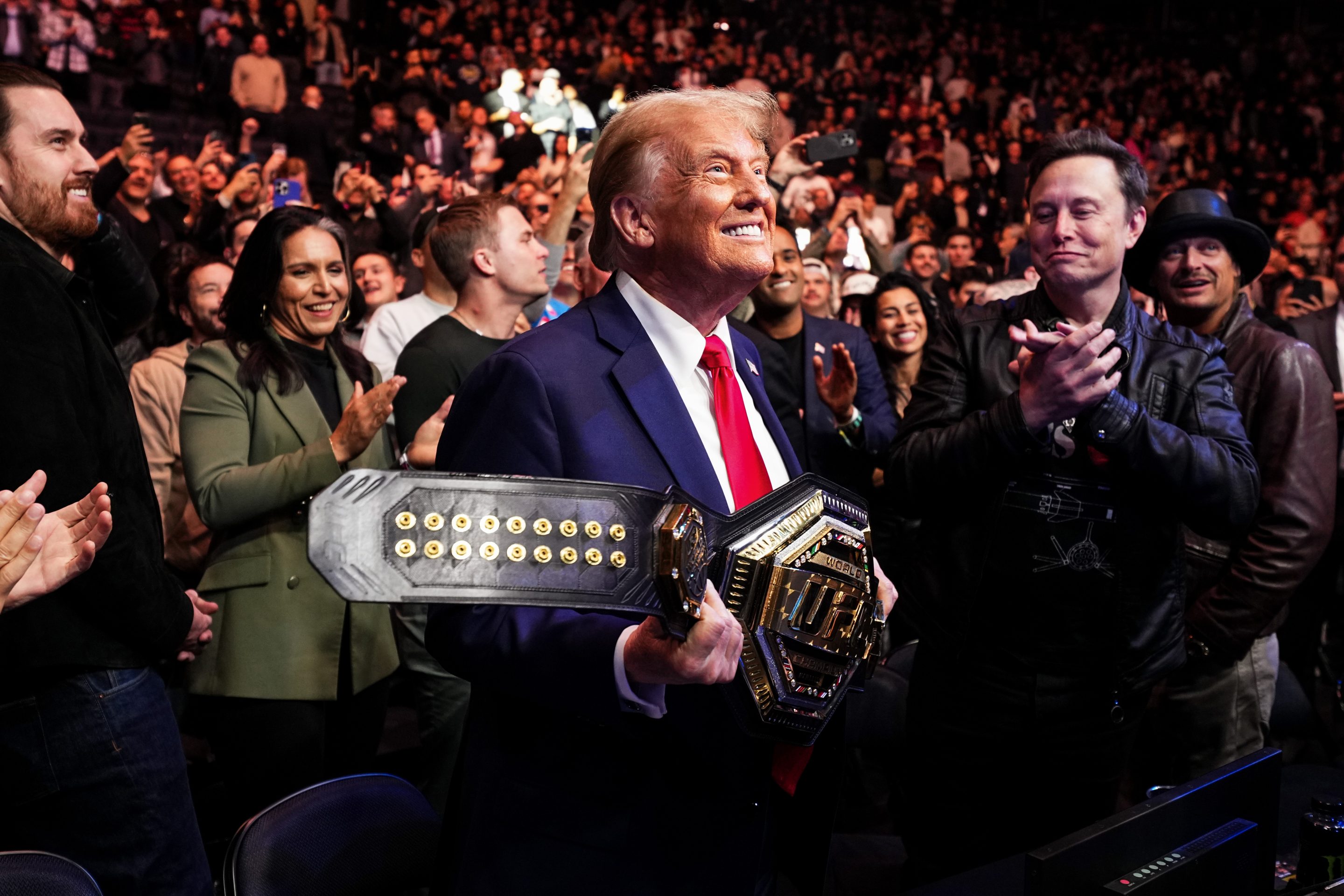 President Donald Trump holds a UFC championship belt in New York City. 