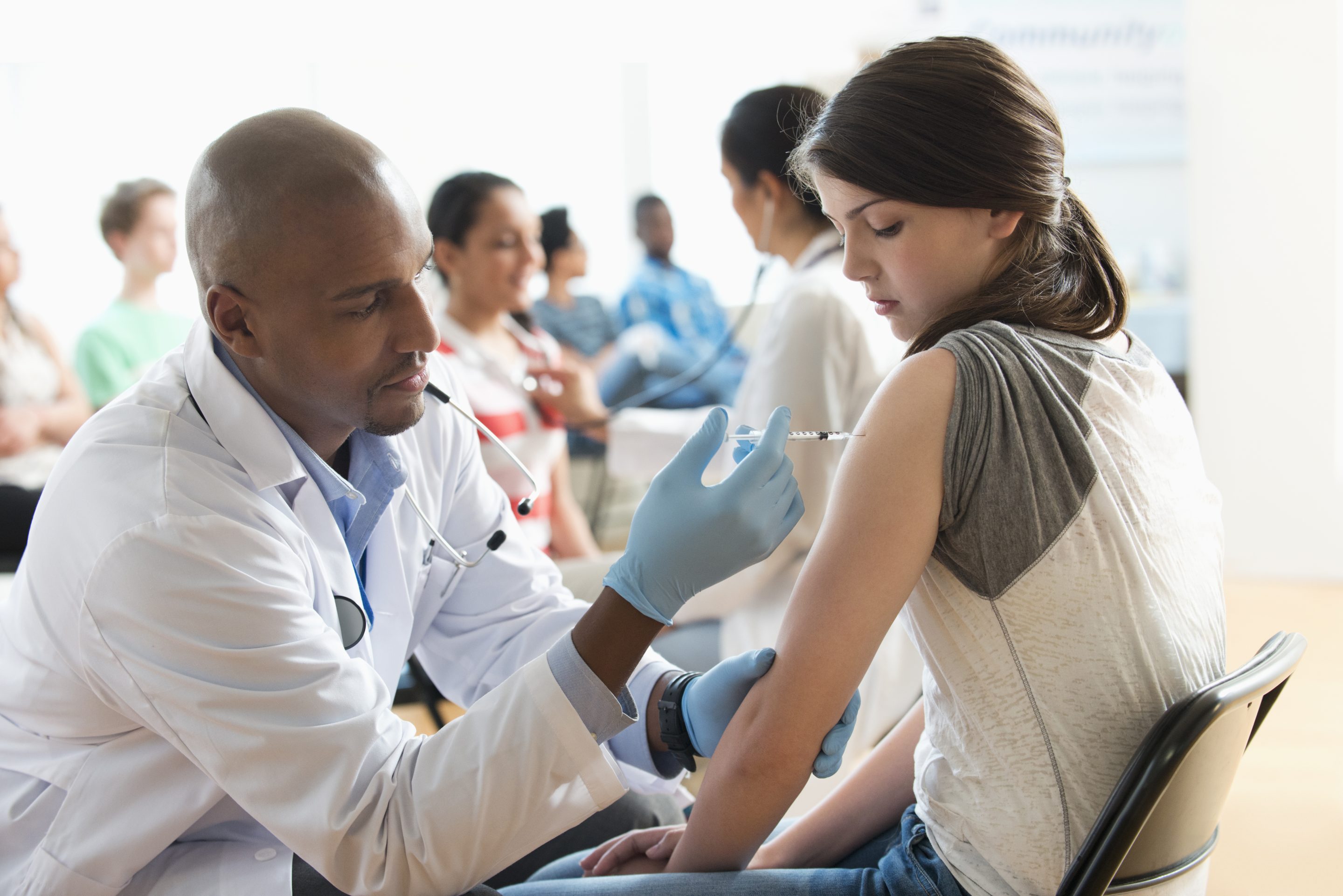 Doctor giving patient injection in volunteer clinic