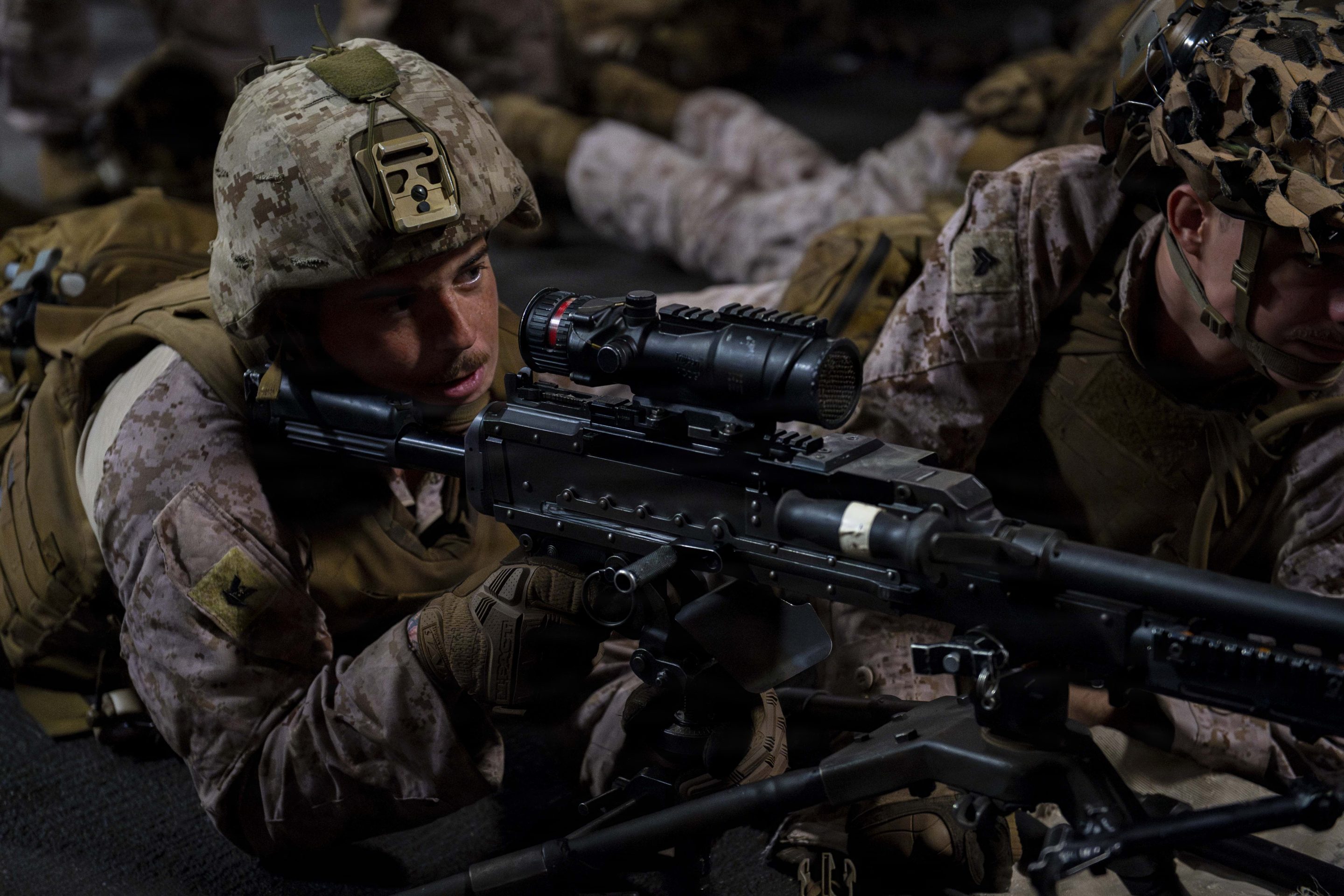 A U.S. sailor, assigned to Battalion Landing Team 3/5, 11th Marine Expeditionary Unit (MEU), participates in a live-fire drill using an M240B machine gun in the upper vehicle deck of Wasp-class amphibious assault ship USS Boxer (LHD 4), July 15, 2026.