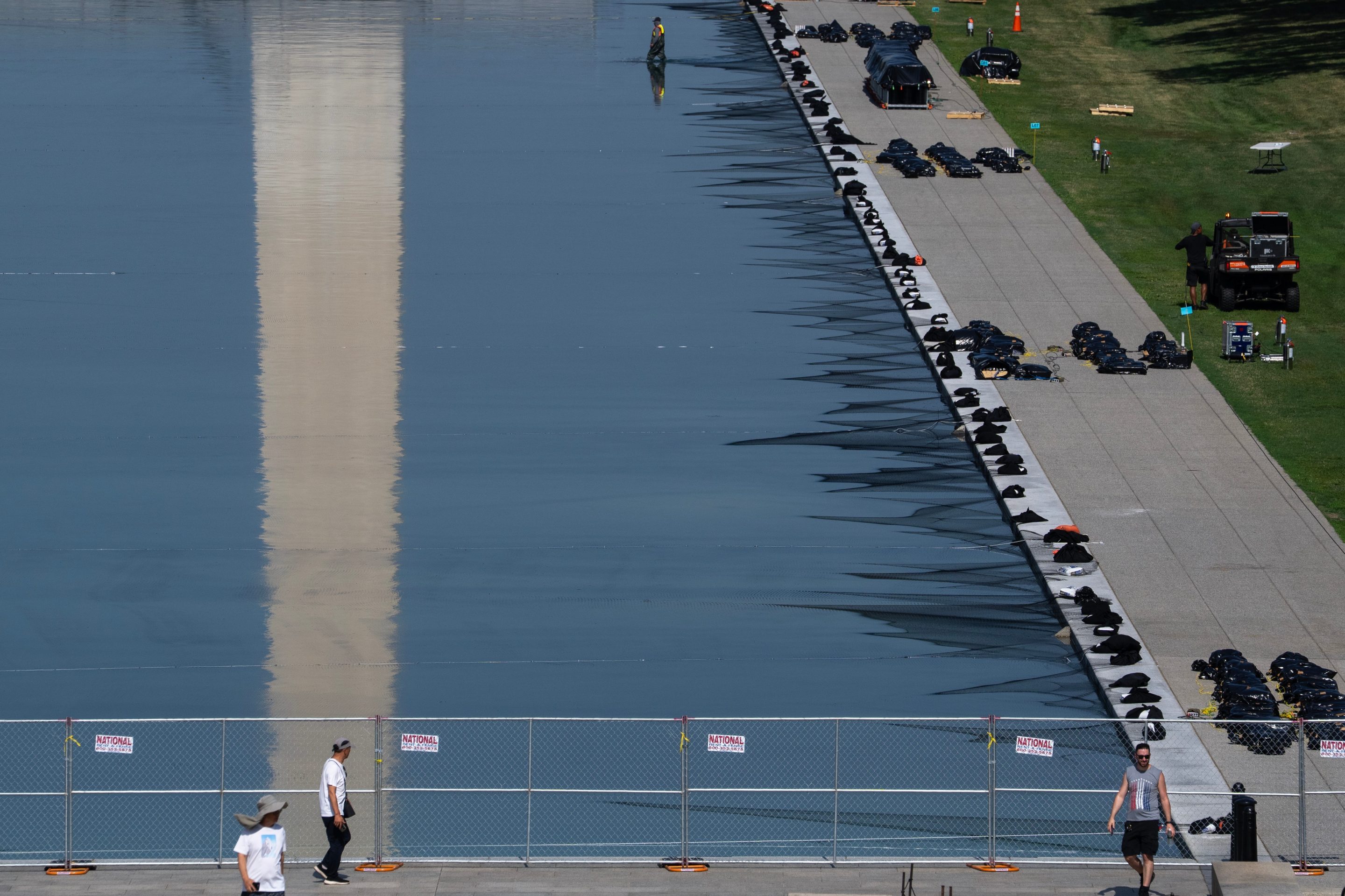 Workers install fireworks along the edge of the Lincoln Memorial Reflecting Pool ahead of the America 250 July 4th celebration on the National Mall, Thursday, July 2, 2026, in Washington. 
