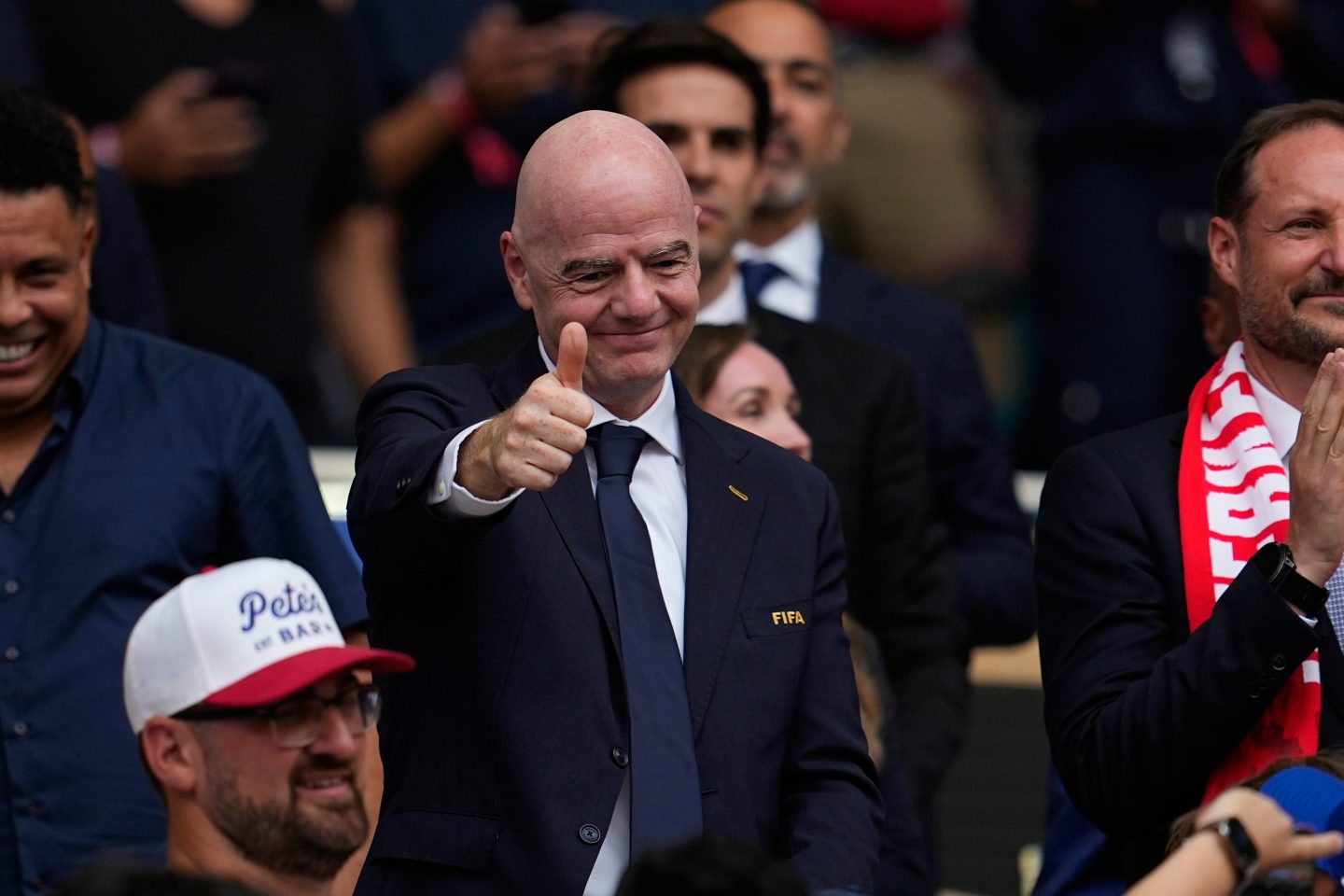 FIFA President Gianni Infantino puts up a hand to show a thumbs up gesture at a World Cup game.