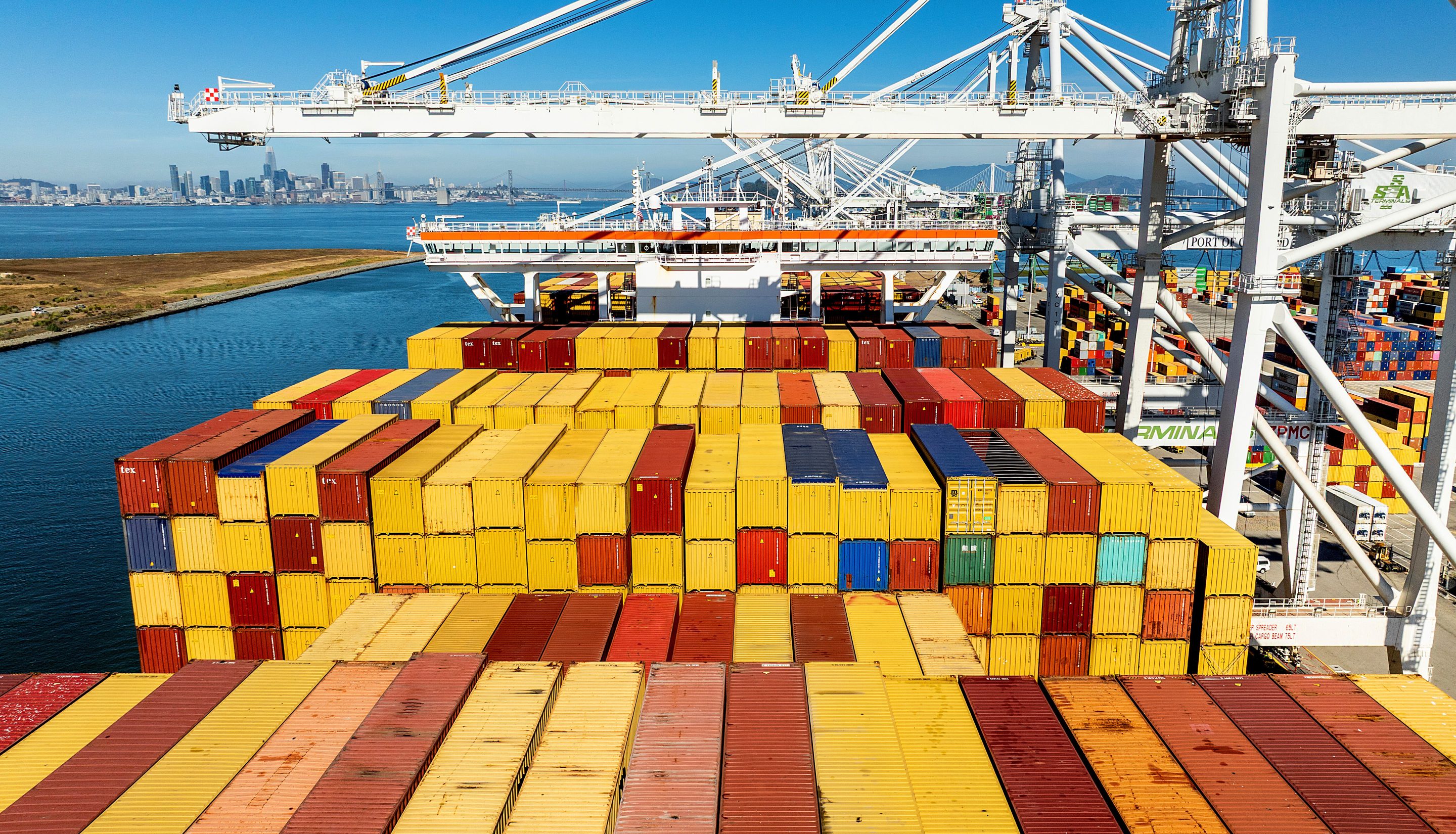 Cargo containers line a ship at the Port of Oakland on Wednesday, Aug. 6, 2025.