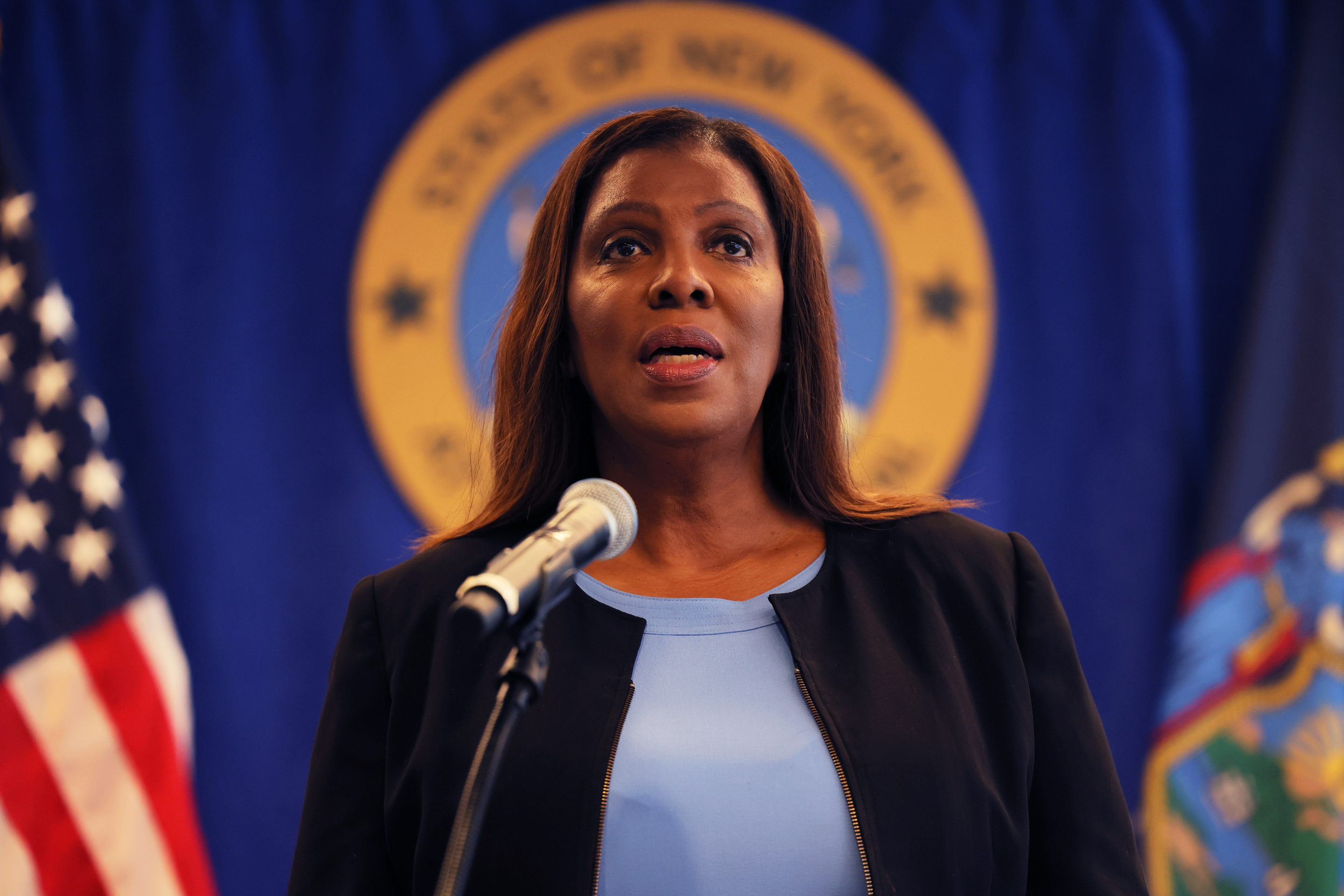 NY AG Letitia James speaks into a microphone.