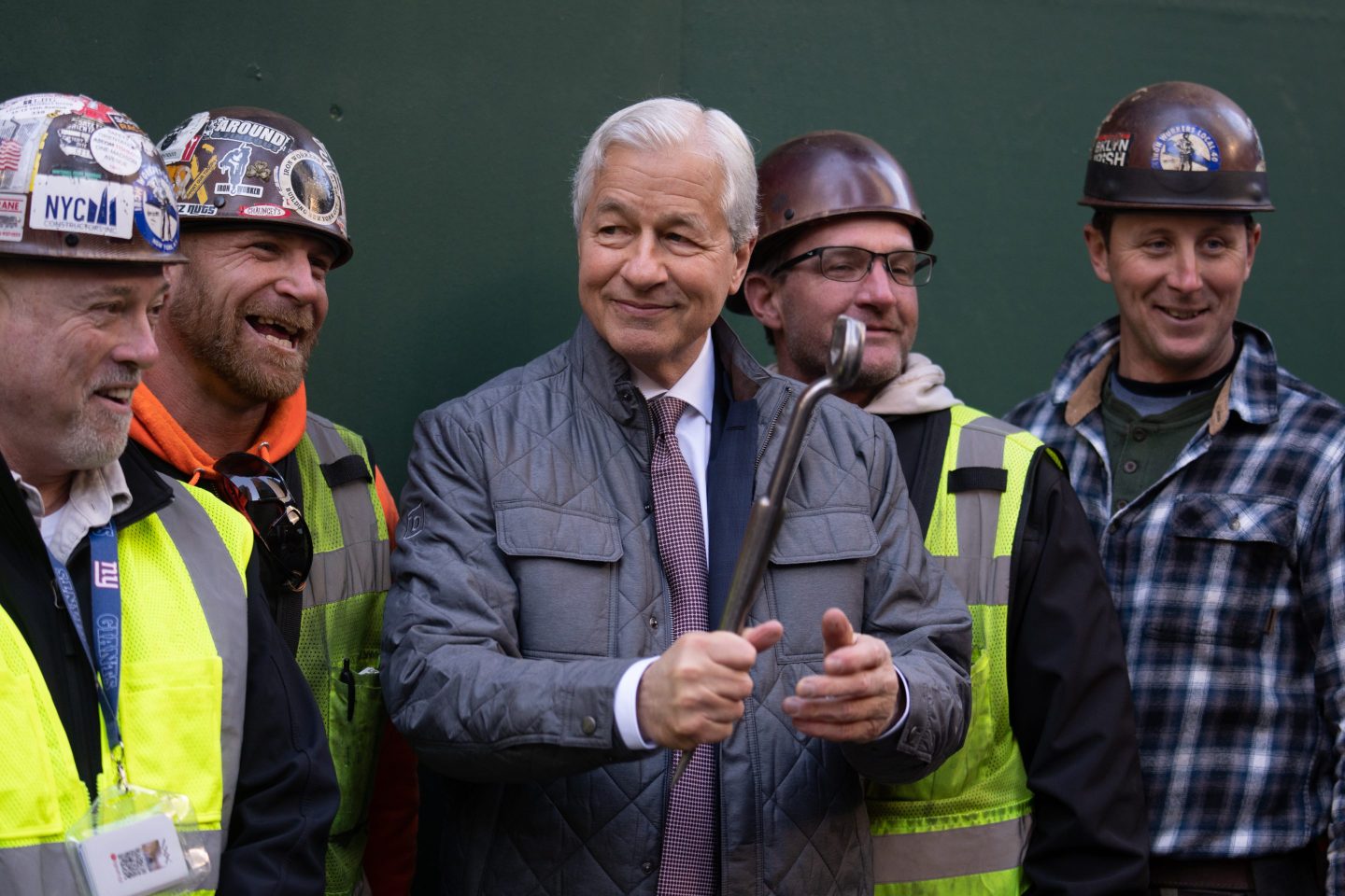 Jamie Dimon surrounded by construction workers.