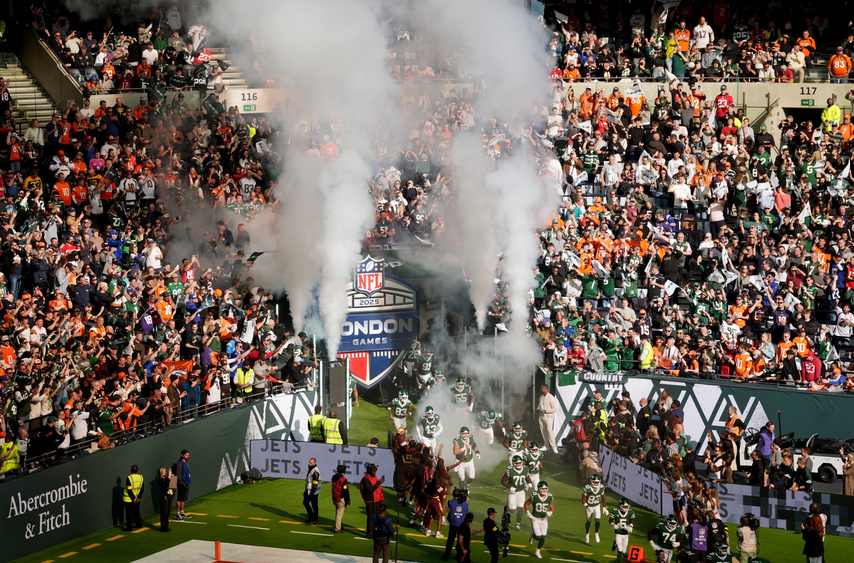 The New York Jets run onto the field at the  Tottenham Hotspur Stadium, London.