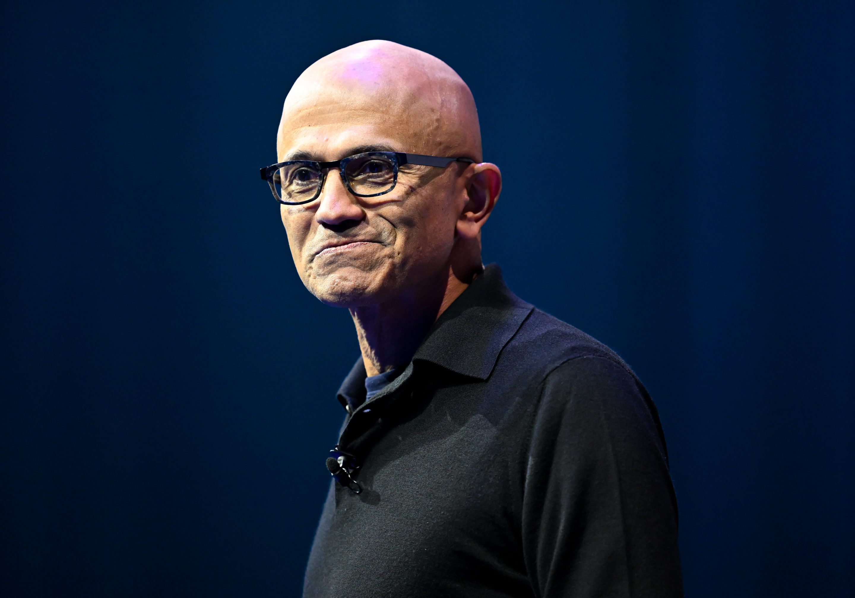 Man with glasses and a black collared shirt