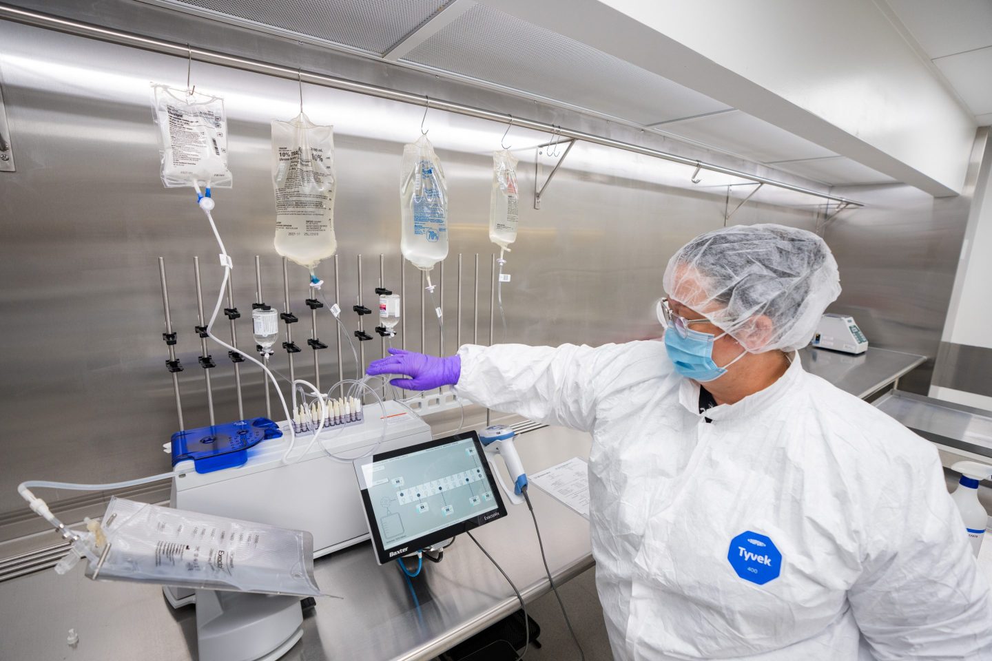 Pharmacy technician Brandy Leroy fills a TPN bag using the ExactaMix Pro Automated Compounding System