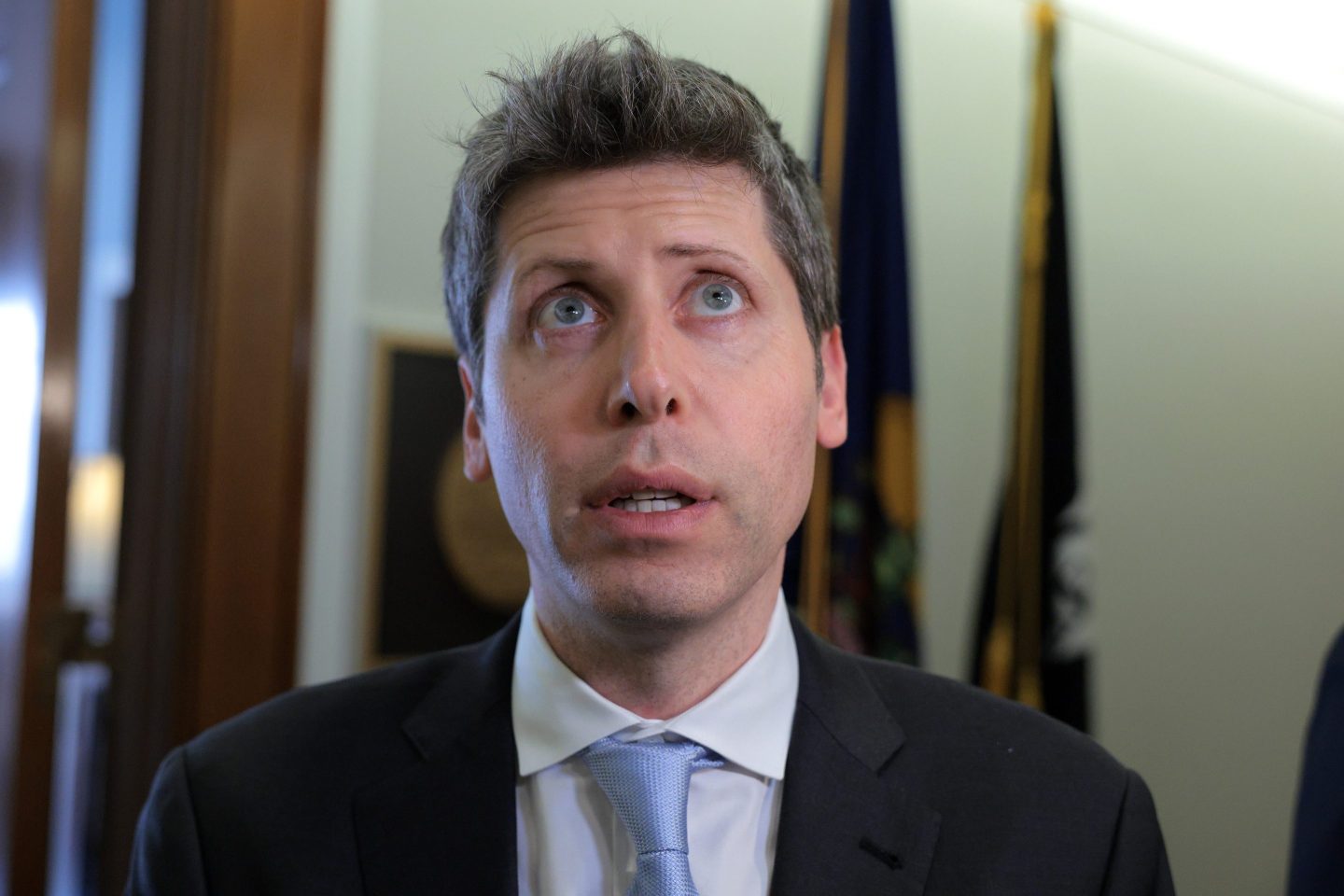 OpenAI CEO Sam Altman looking up.