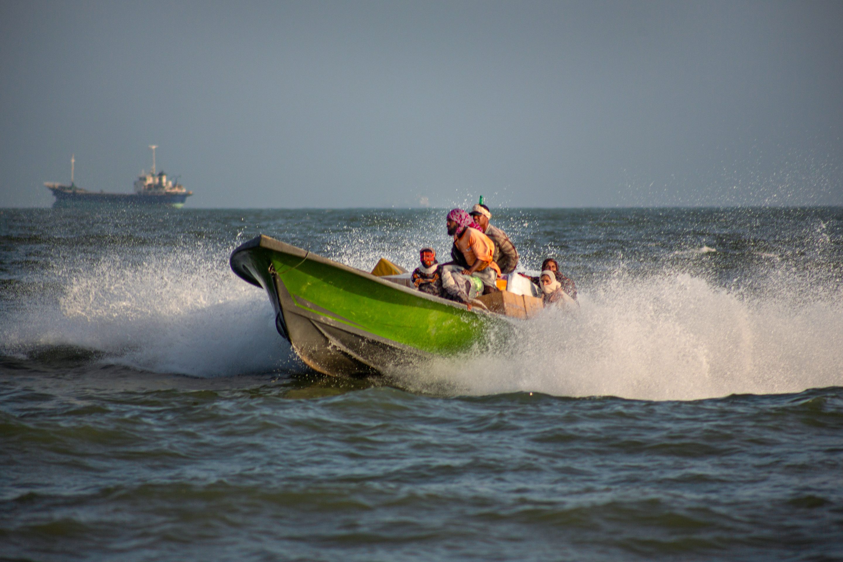 BANDAR ABBAS, IRAN - JUNE 25: People unload goods from a small boat along the coast of Bandar Abbas, southern Iran, following a temporary reduction in military tensions in the Strait of Hormuz.