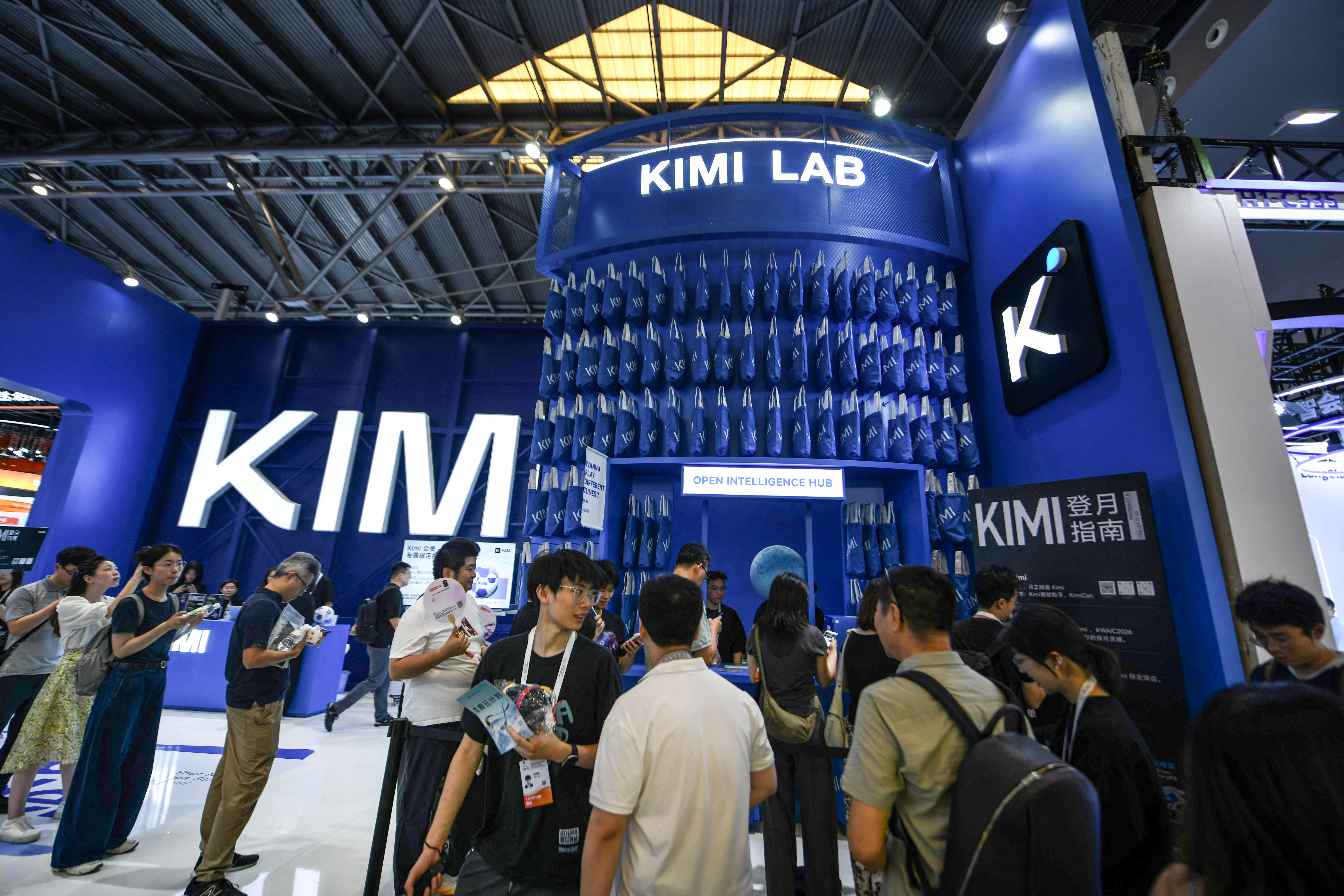 People visit the Moonshot AI stand, featuring Kimi K3, during the World Artificial Intelligence Conference (WAIC) in Shanghai on July 17, 2026.
