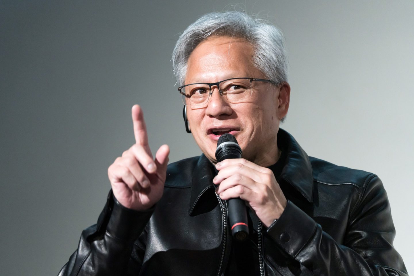Jensen Huang speaks into a microphone