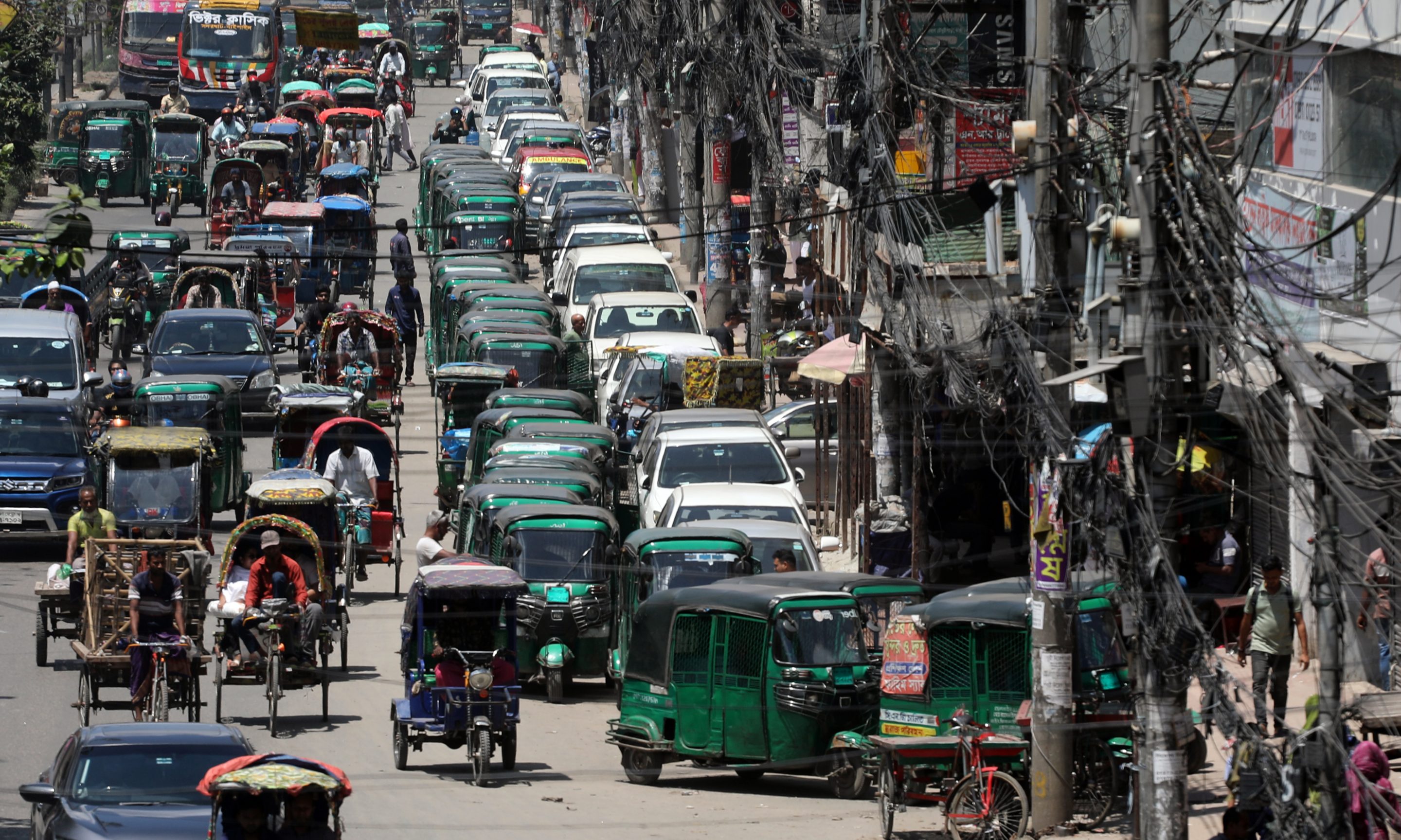 Compressed natural gas-powered rickshaws and vehicles wait in long queues outside a filling station in the Malibagh area of Dhaka, Bangladesh, on July 25, 2026, after gas supplies were suspended amid a gas shortage linked to disruptions in LNG supply. Drivers spend hours waiting in the hope that gas service will resume, while the shortage continues to disrupt public transportation, private commuting, and daily life across the capital.